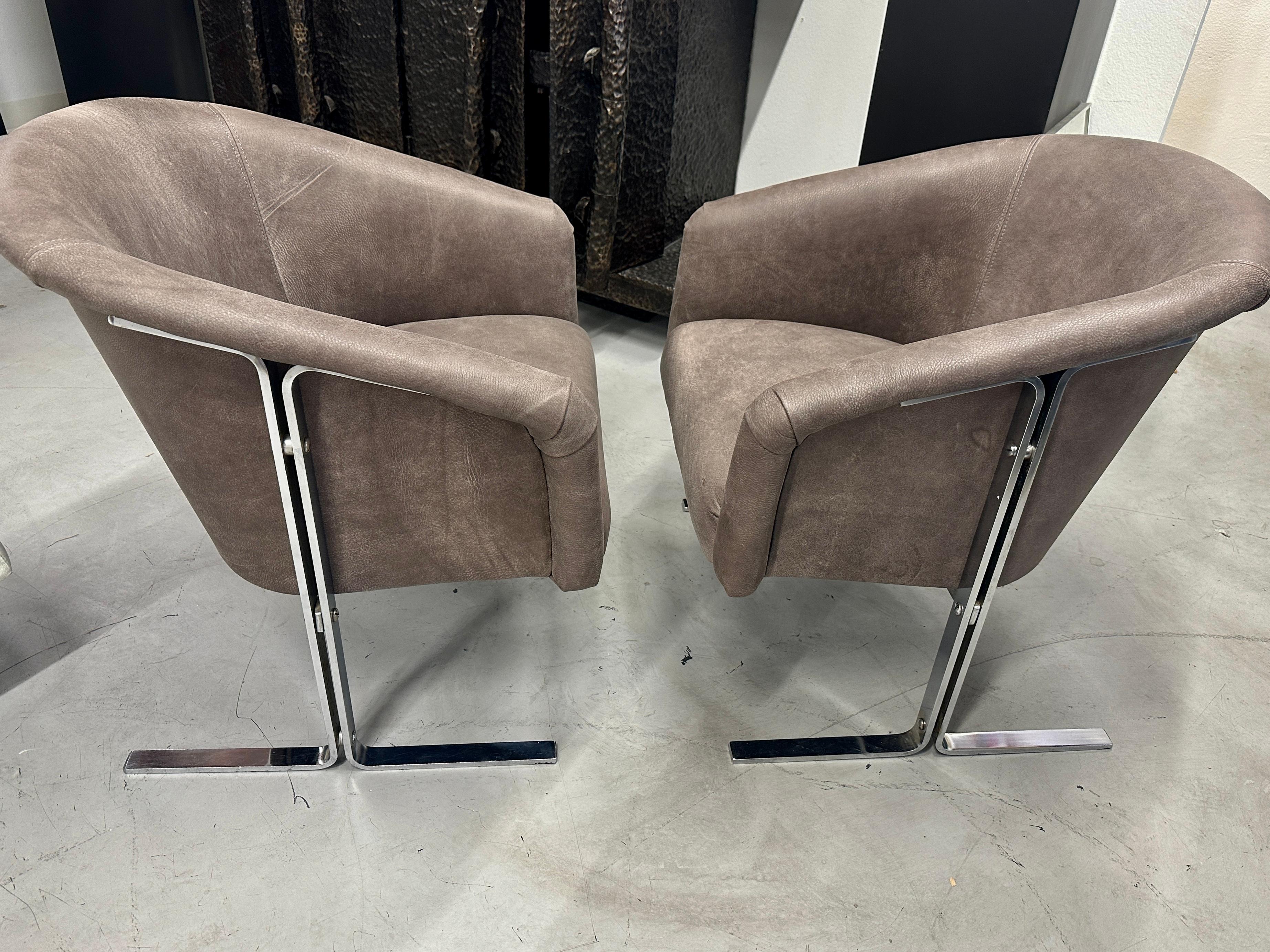 A beautifully re-upholstered chromed steel armchairs. They have been redone in a wonderful distressed heavy leather. Not sure as to the manufacturer but they clearly look to be influence by Milo Baughman designs. The distressed leather has a