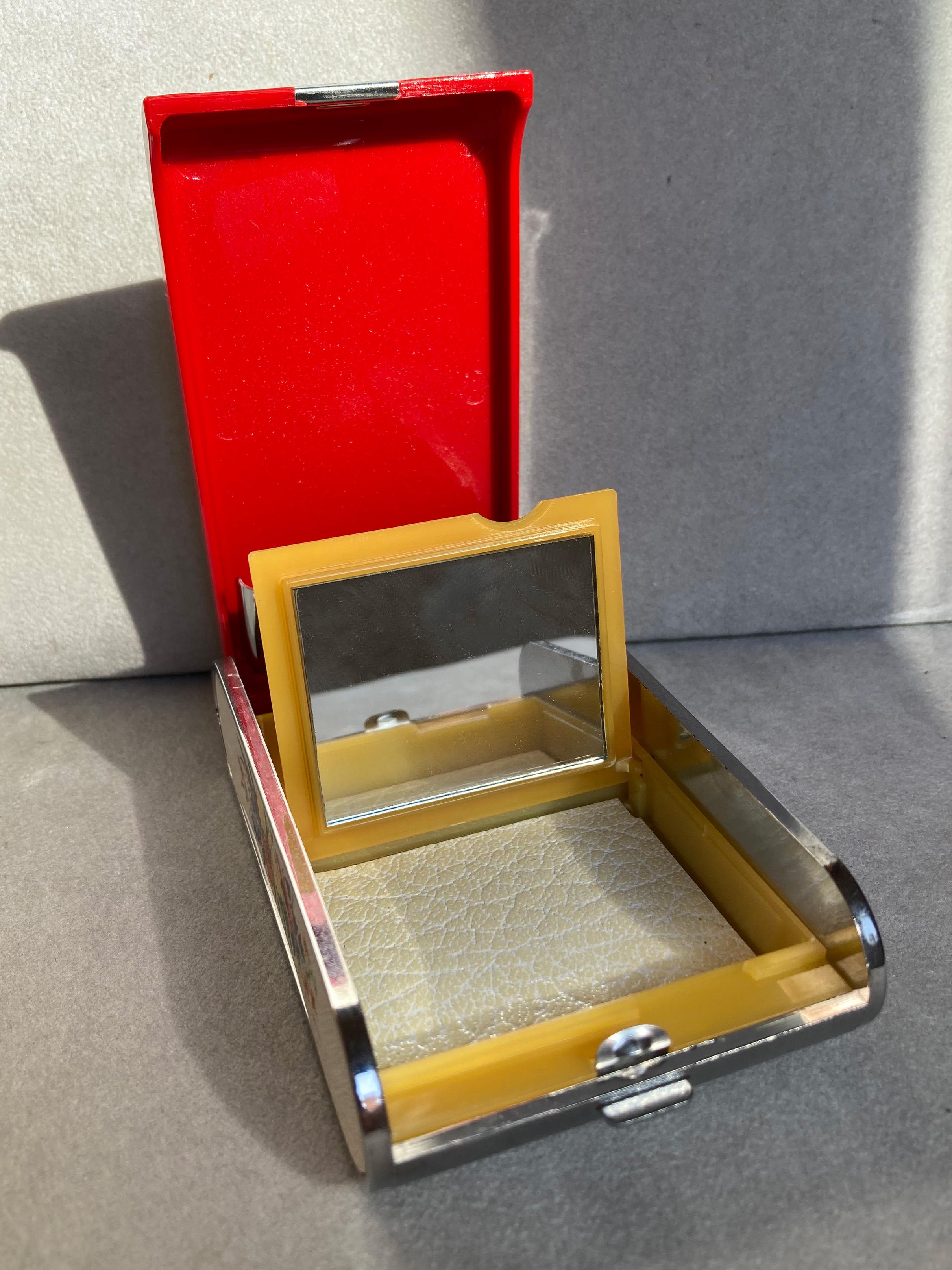 A Charming Musical Powder Compact and Cigarette Case made by Dandy-Mate Silvia in fabulous working condition. Circa: 1970's. Japan. Bitone plastic (red & white) and gold plated metal details.
Face powder container with small mirror.
Measures: 10,4