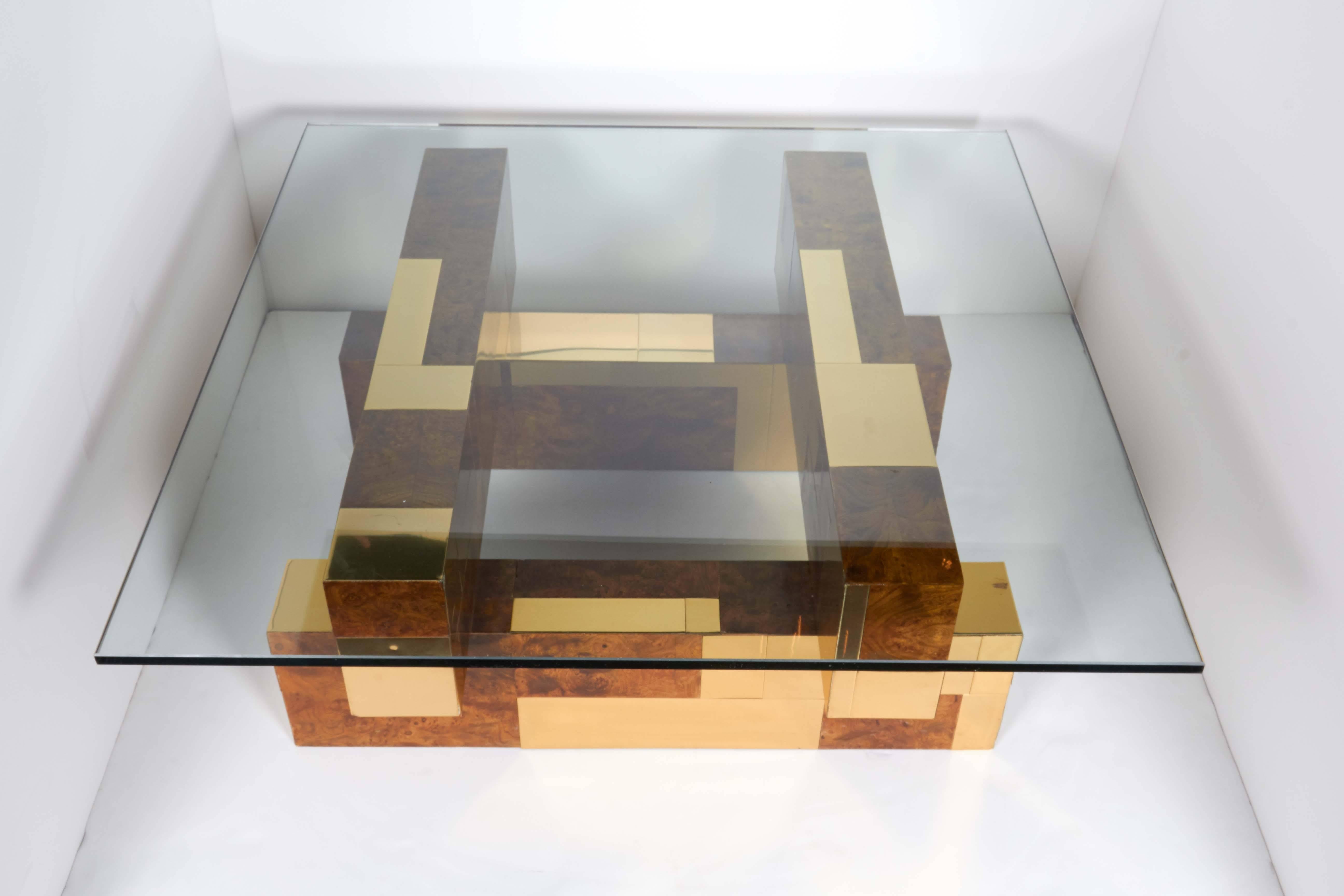 Mid-Century Modern coffee table from the Cityscape series by Paul Evans. Cubist form with rare patchwork design in burled wood veneer offset by striking brass insets. Has square glass top with polished edges.