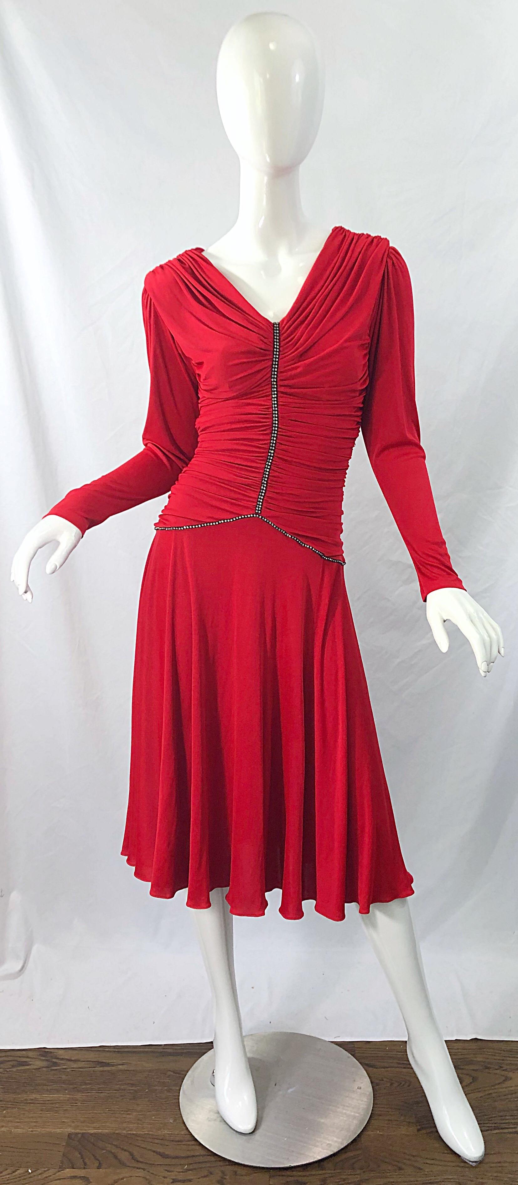 Beautiful late 1970s CLARALUNA ORGINIAL lipstick red rhinestone encrusted long sleeve vintage jersey dress ! Features a tailored flattering ruched bodice, with rhinestones down the front center and waistband. Soft rayon stretches to fit. Hidden