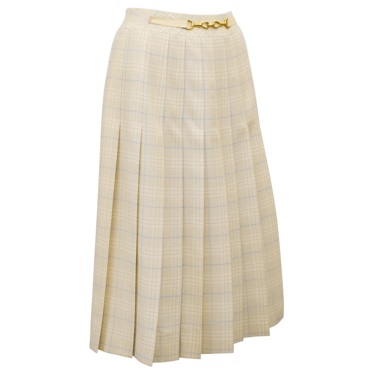 1970's classic Celine cream and pale blue wool tartan pleated skirt with half cream leather and gold belt at waistband. Inverted stitched pleats on the front and back. Overall A line shape. In excellent condition, side zipper with hook and eye. Fits