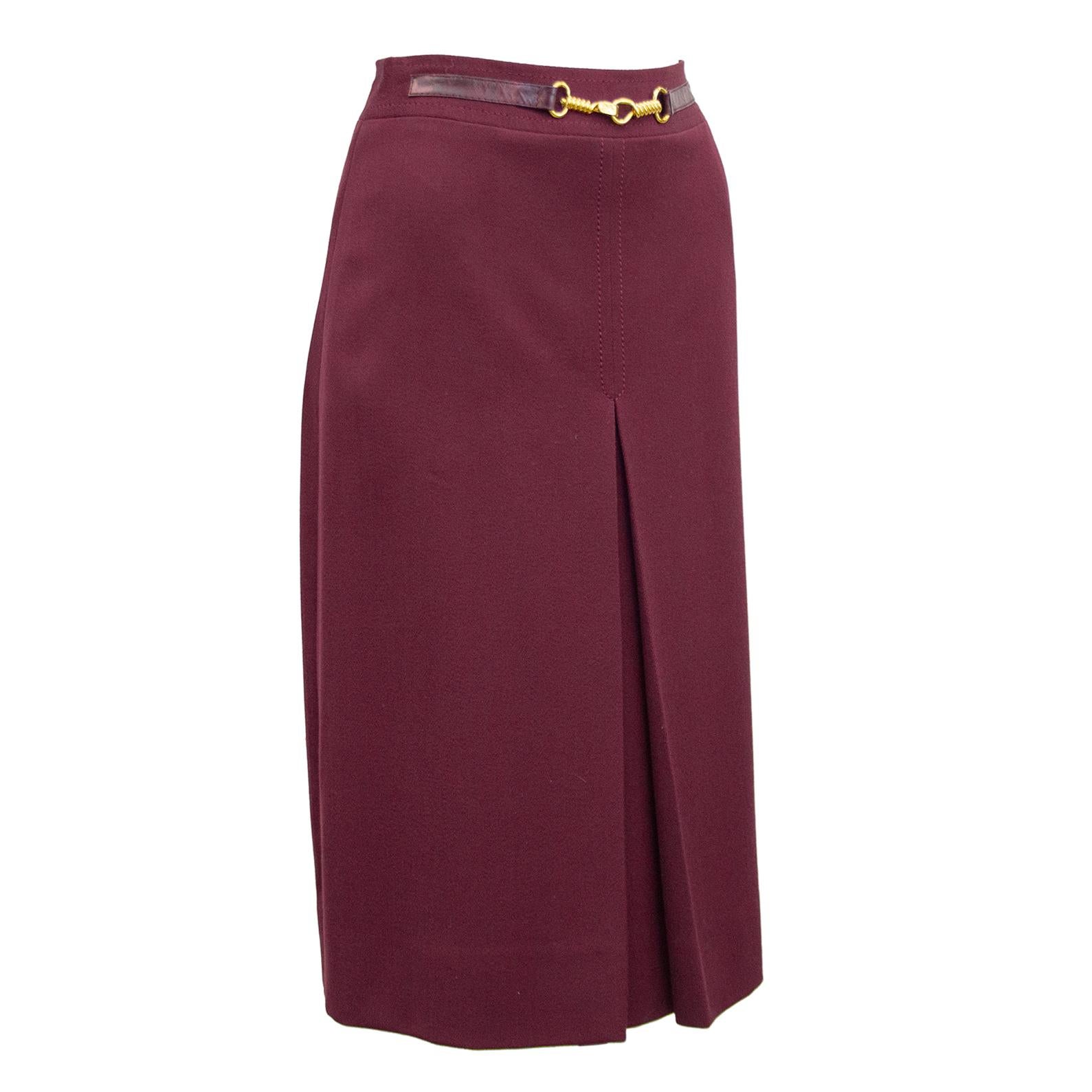 1970's classic Celine maroon wool gabardine skirt with half maroon leather and gold belt at waistband. Inverted stitched single box pleat on the front and back. Overall A line shape. In excellent condition, side zipper with hook and eye. Fits like a