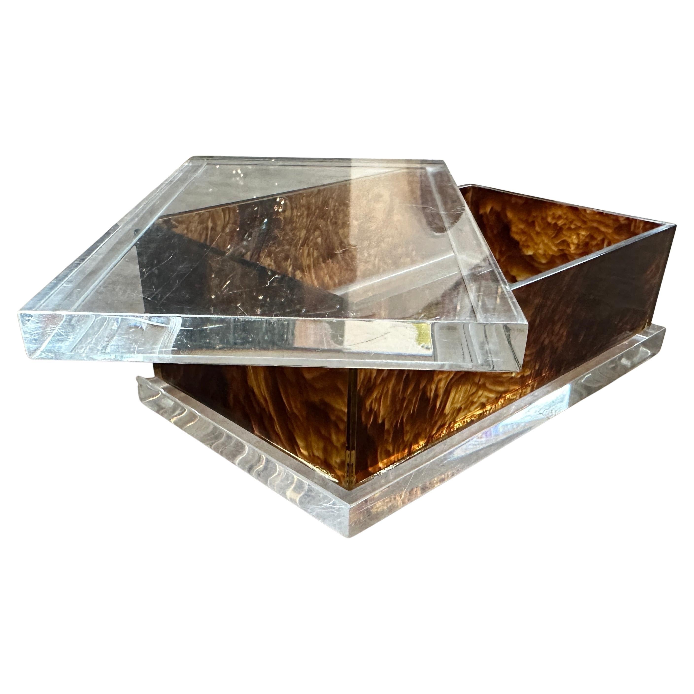 A glamorous 1970s vanity or utility box, crafted from a striking combination of clear and faux tortoiseshell Lucite/acrylic, designed in the elegant manner of pieces by Dior Home or other high-end Italian and French makers of the era. The piece
