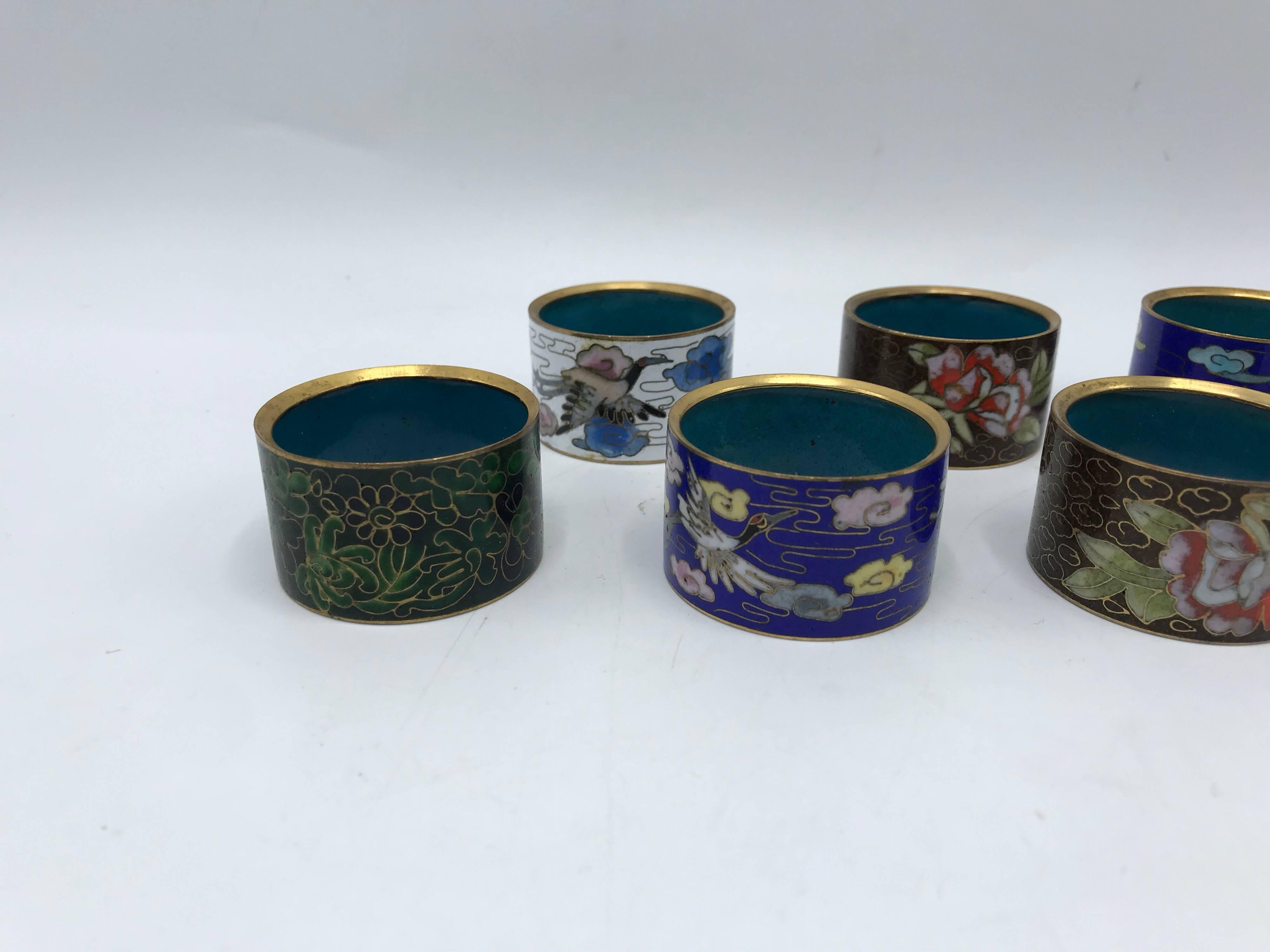 Offered is a beautiful, set of eight, 1970s cloisonné napkin rings. Four pairs, all the same size with different designs, complimentary of the entire set.