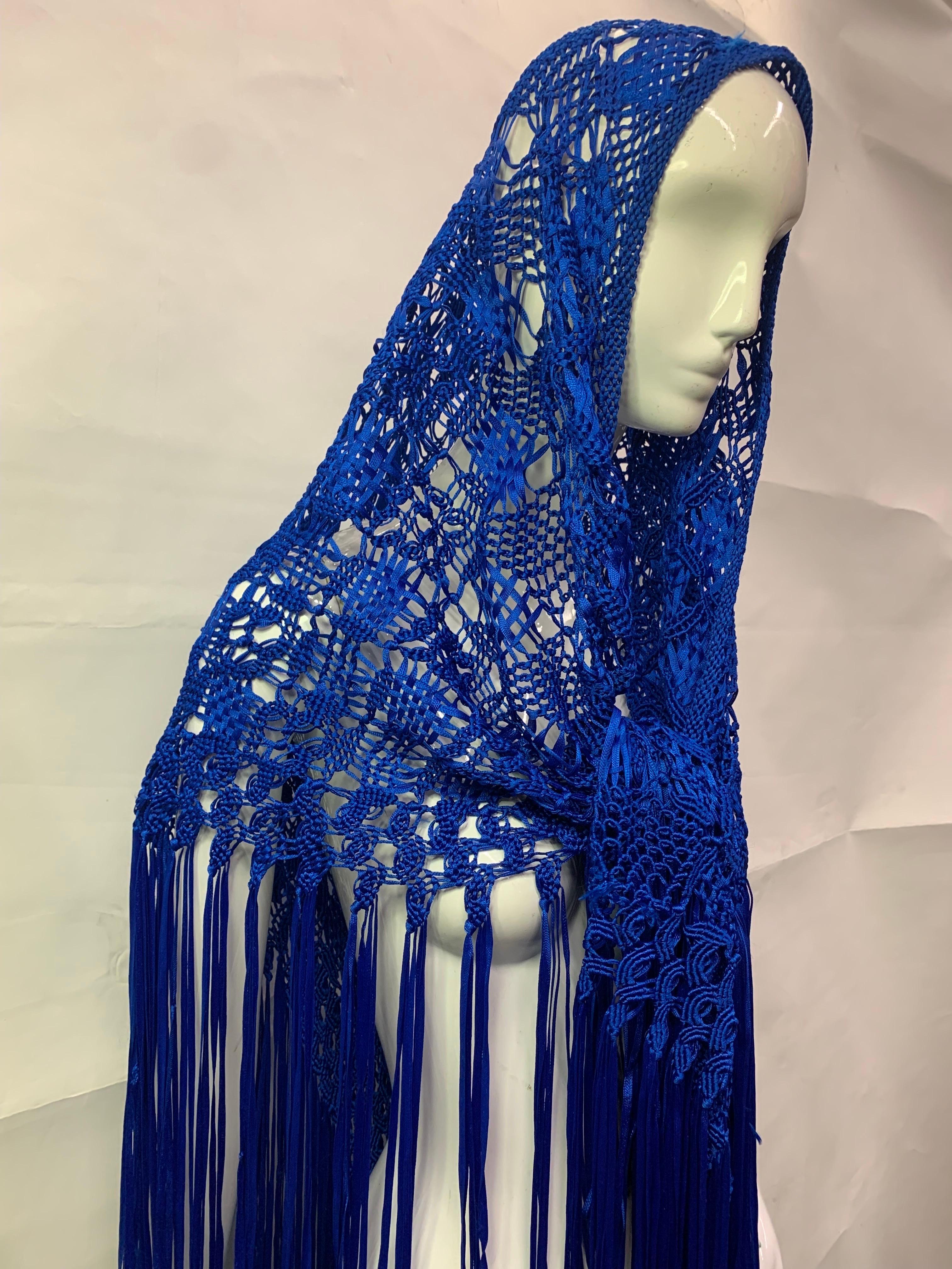 1970s Cobalt Blue Rayon Ribbon Macrame Shawl with Extravagant Fringe:  This exuberant example of beautifully executed macrame with make a big blue splash at a party! Large triangular shape. One size fits all. 