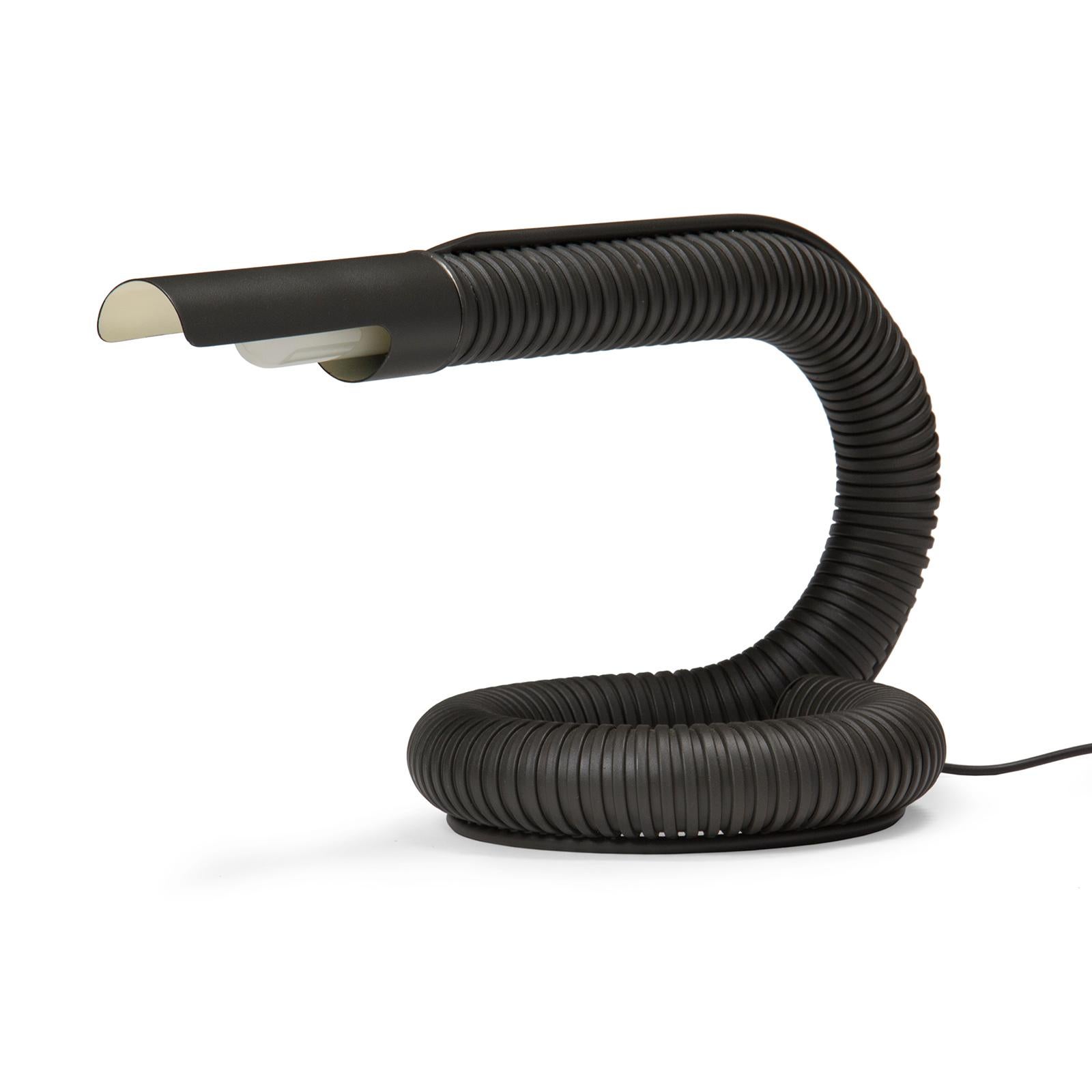 A black gooseneck 'Cobra' desk lamp resembling a hose that forms a coil base.