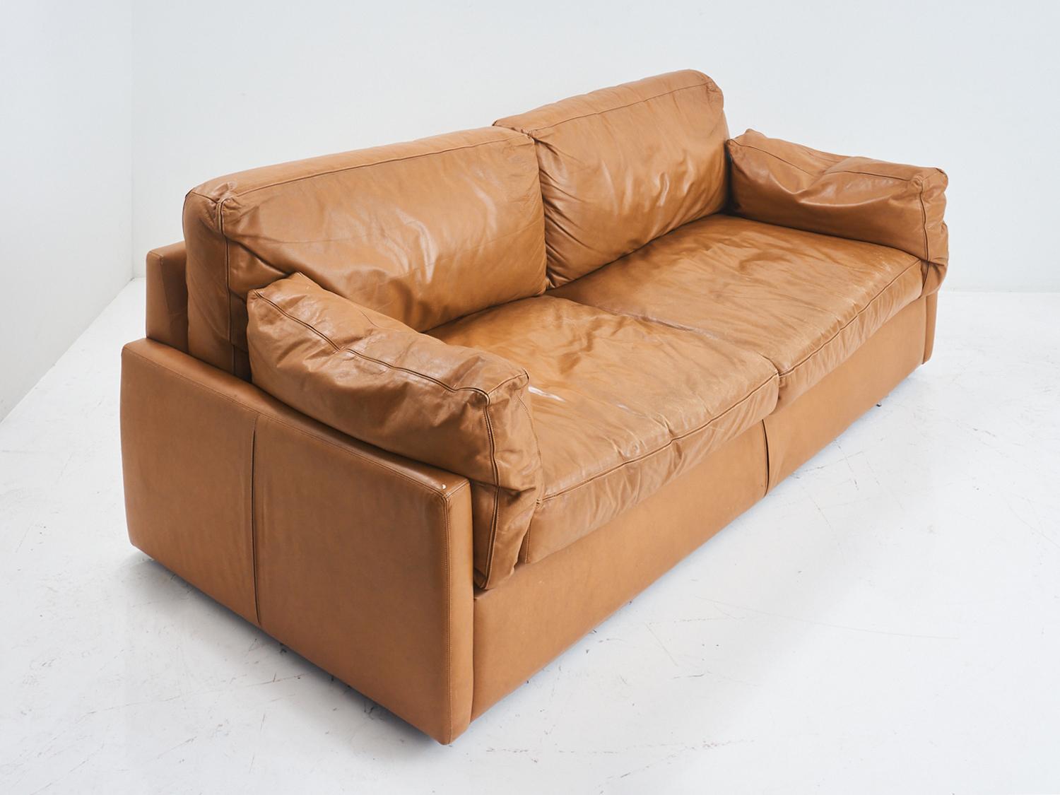 With its rich, warm hue and buttery soft texture, this sofa will elevate your living space to the next level of sophistication. So grab a glass of your favorite cognac and sink into its plush embrace, because with this sofa, your relaxation just got