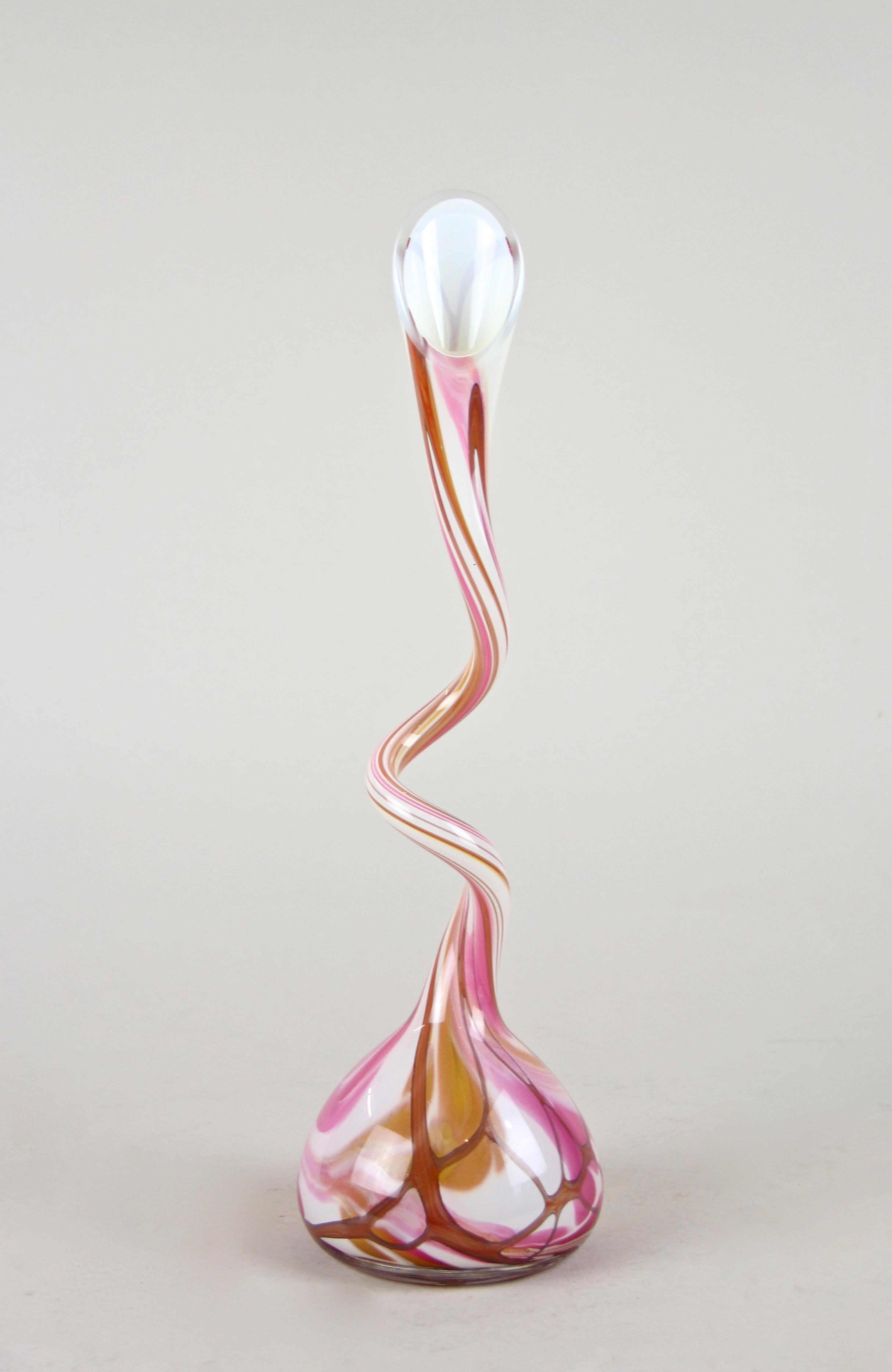 Unusual 1970s colored flashed glass vase out of Austria. The dainty glass vase impresses with fantastic coloration in pink and brown tones and an exceptional twisted design, reminding of a calla lily. The bulbous body transforms into a slim, double