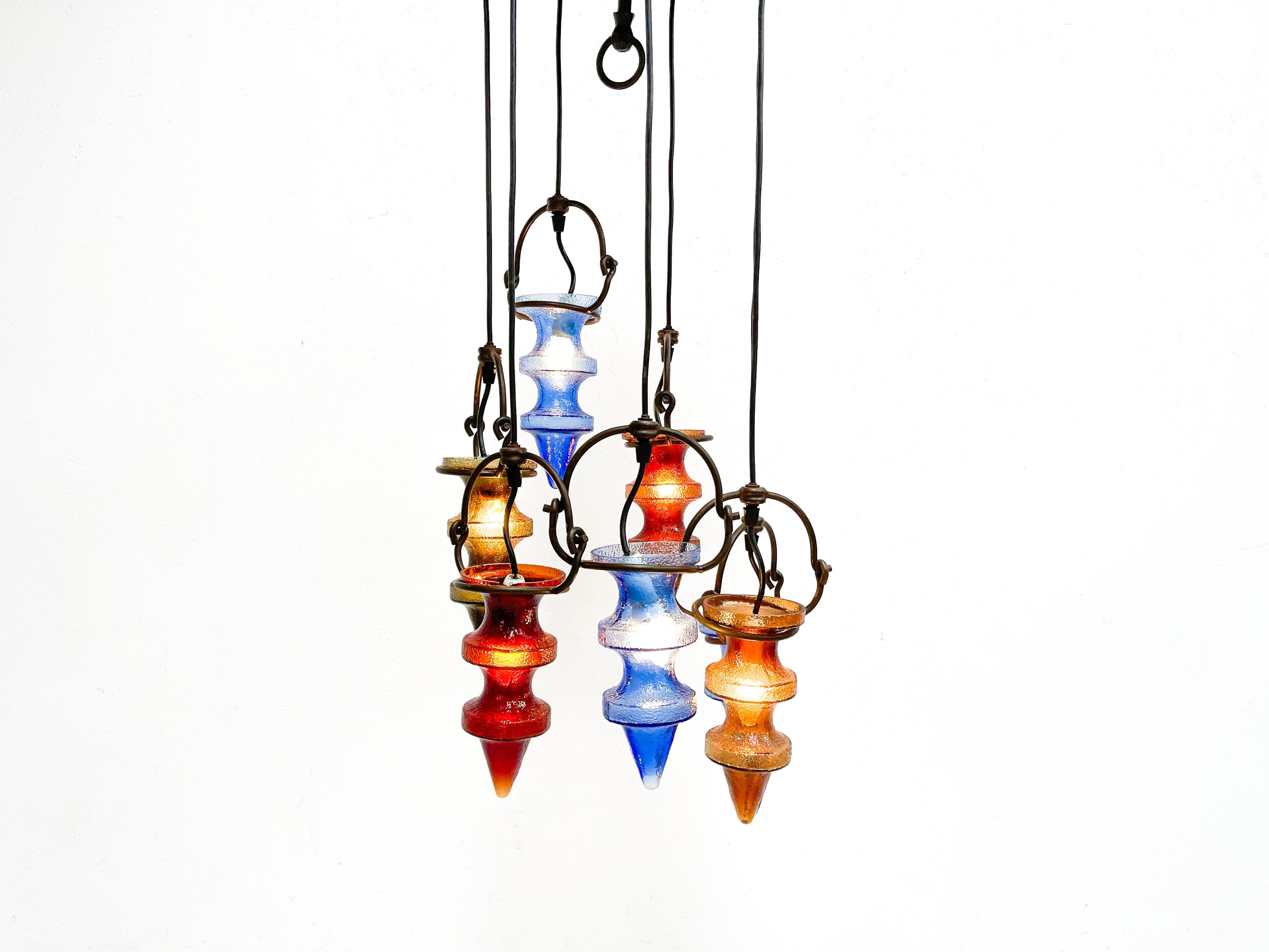mpressive glass chandelier by famous Finnish designer Nanny Still. This chandelier was produced in the 1960's by Belgian manufacter Massive. This chandelier has the typical colored glass 