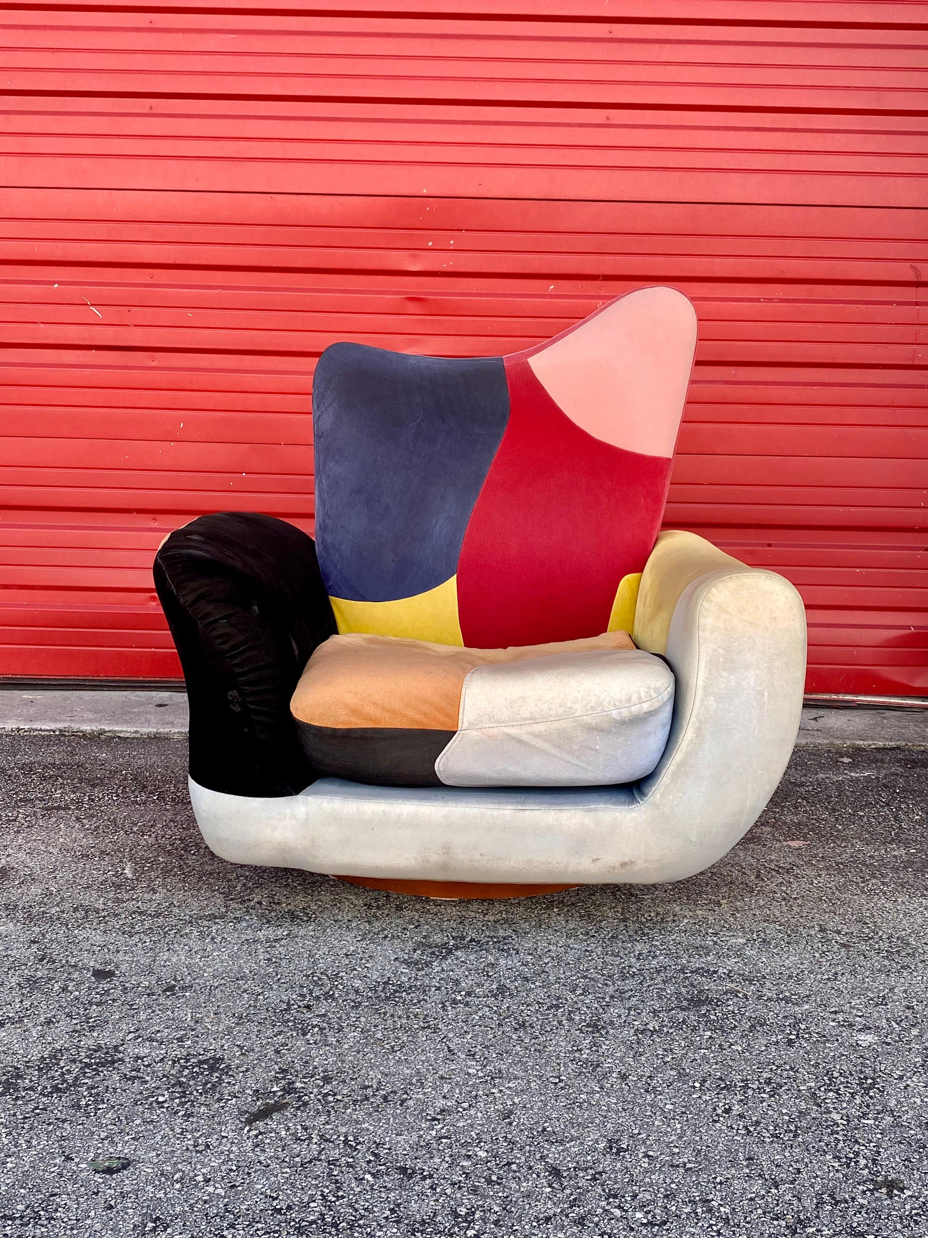 The beautiful rare swivel chair is statement piece which is also extremely comfortable and packed with personality! Attributed to Adrian Pearsall. Just look at the gorgeous lines and curves on this beauty! Plush colorful cushioning and an