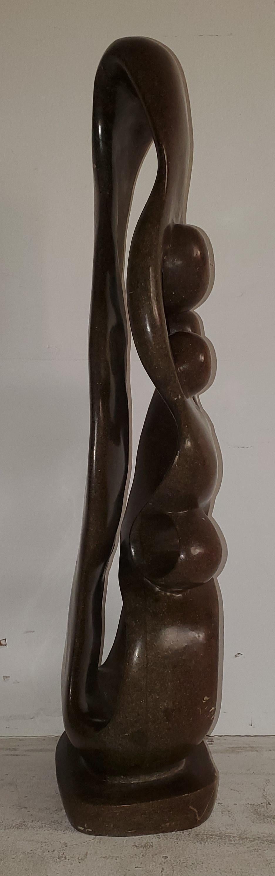 Beautiful sculpture of a family unity and circle of trust in an Architectural free form. This 29inch sculpture is made from stone and is heavy. Great base and sturdy. A great piece with life.
