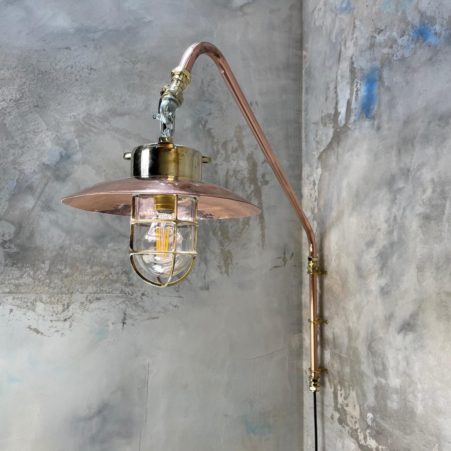 Copper and brass cantilever lamp with brass explosion proof pendant.

A solid cast brass reclaimed light fitting with new copper pipe cantilever, made in house.

The reclaimed explosion proof light was originally used on super tankers and cargo