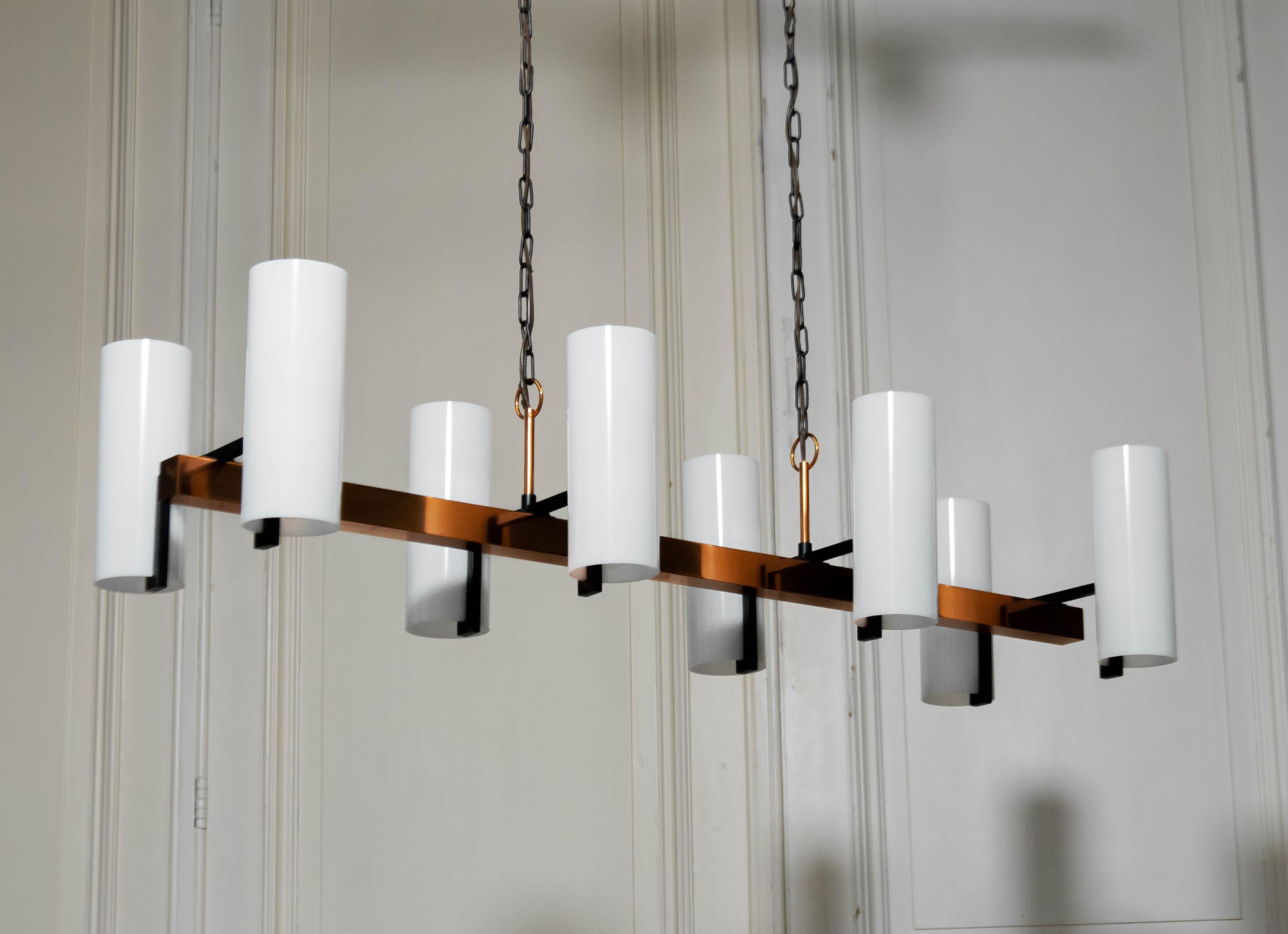 Beautiful 1970s horizontal copper chandelier attributed to Jo Hammerborg for Fog & Mørup Denmark.
The eight glass shades are replaced for new acryl shades measuring similar .
Height of te vases is 21 cm and the ø is 8 cm.
Technically in good