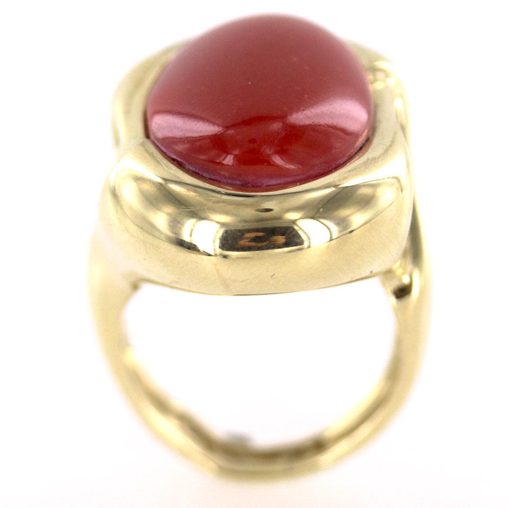 Beautiful bold coral stands alone in this contemporary ring. The red coral measures 15 x 20mm and is set in a contemporary polished 14 karat yellow gold mounting. The ring is currently size 8 (can be sized) and measures 1.0 inch in width. 