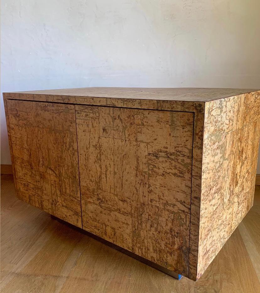 Phenomenal piece, attributed to Adrian Pearsall/Craft Associates from a super scarce line of cork furnishings.
Cork cabinet on raised mirrored plinth base, with cork interior.
The textural, organic materials and 70s Modernist design come together