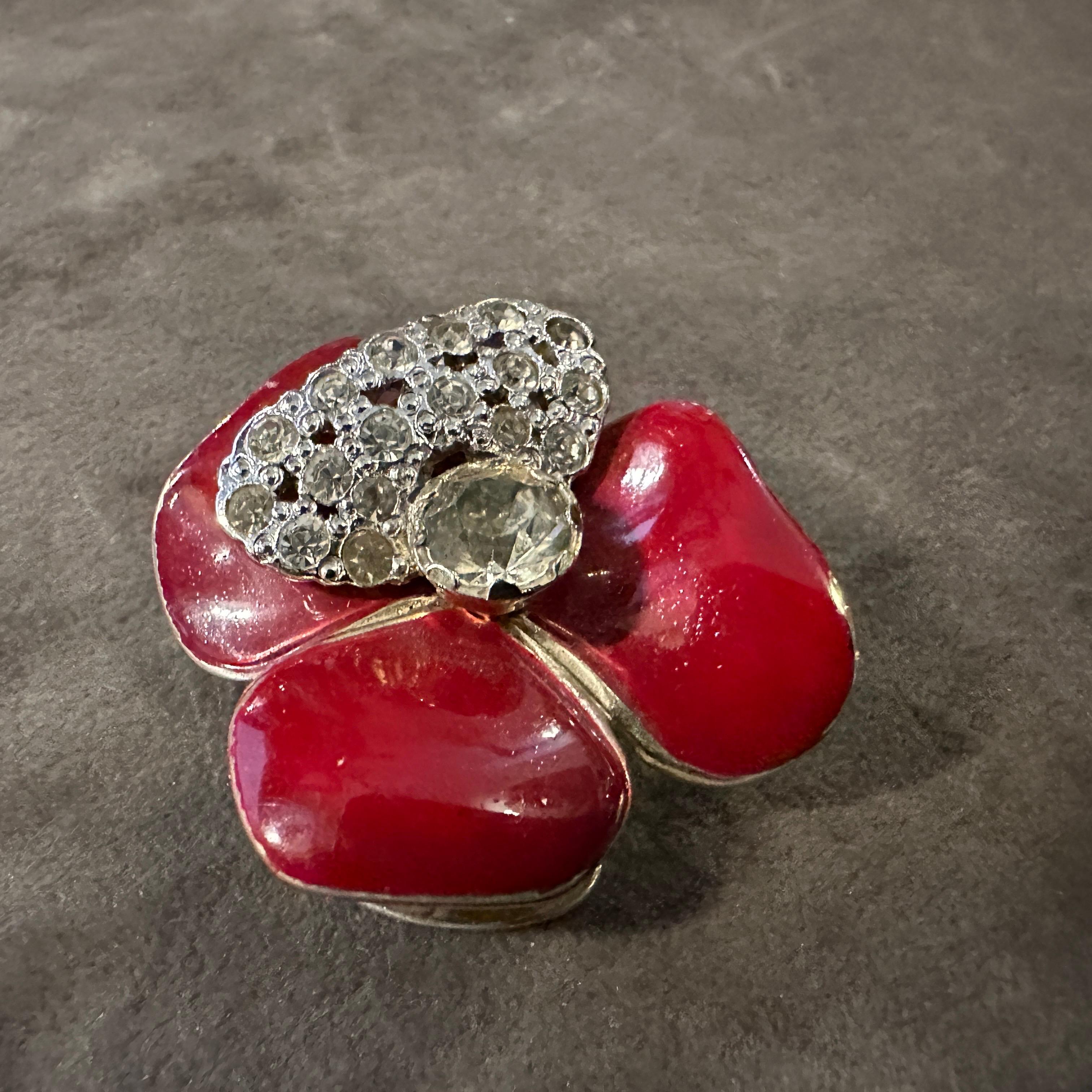 These glamorous 1970s Valentino Costume Jewelry Clip-on Earrings are a dazzling nod to the bold and opulent style of the era, crafted with the house's signature elegance and flair.  Shaped like vibrant red blossoms, each earring mimics a stylized