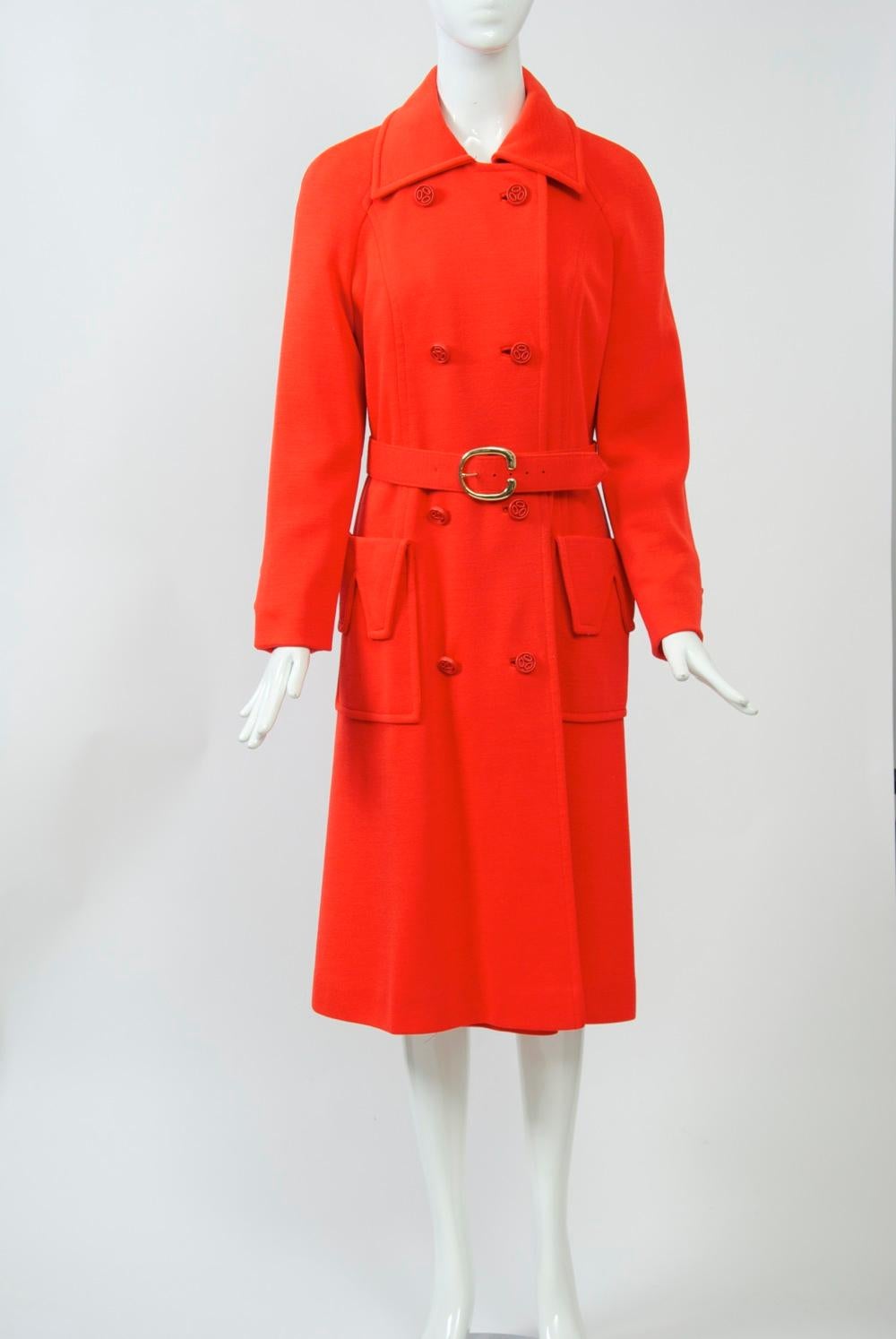 Count Romi specialized in all-weather coats, as well as those suitable for travel. This example, from the early 1970s, is crafted of bright red wool knit and features double-breasted styling, deep patch pockets with cutout flap, and wide self belt.