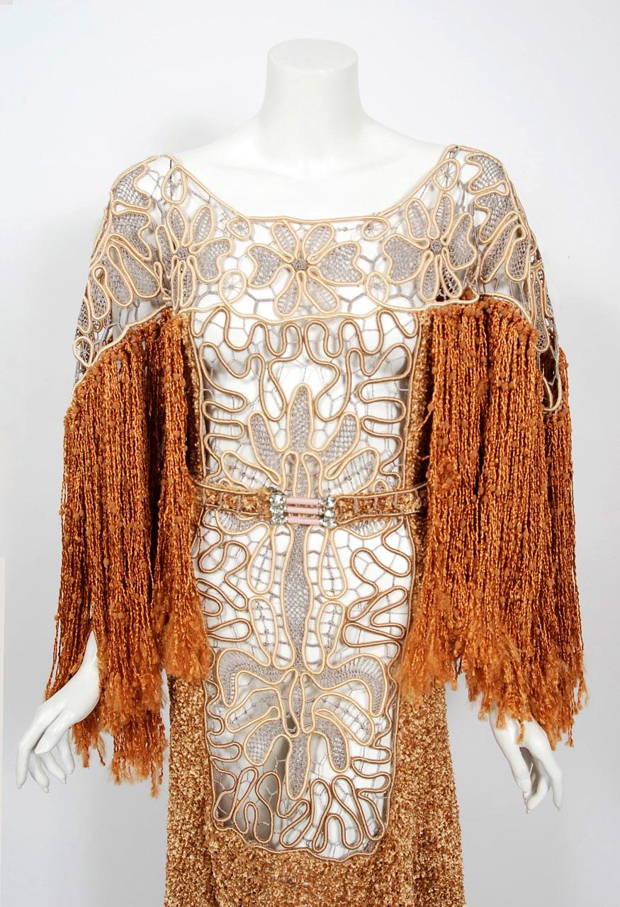 An alluring 1970's British custom couture copper knit and corded lace gown that effortlessly mixes the bohemian vibe with 1930's Old Hollywood glamour. The fabrics used are breathtaking; hand finished corded beige tape lace and shimmering copper