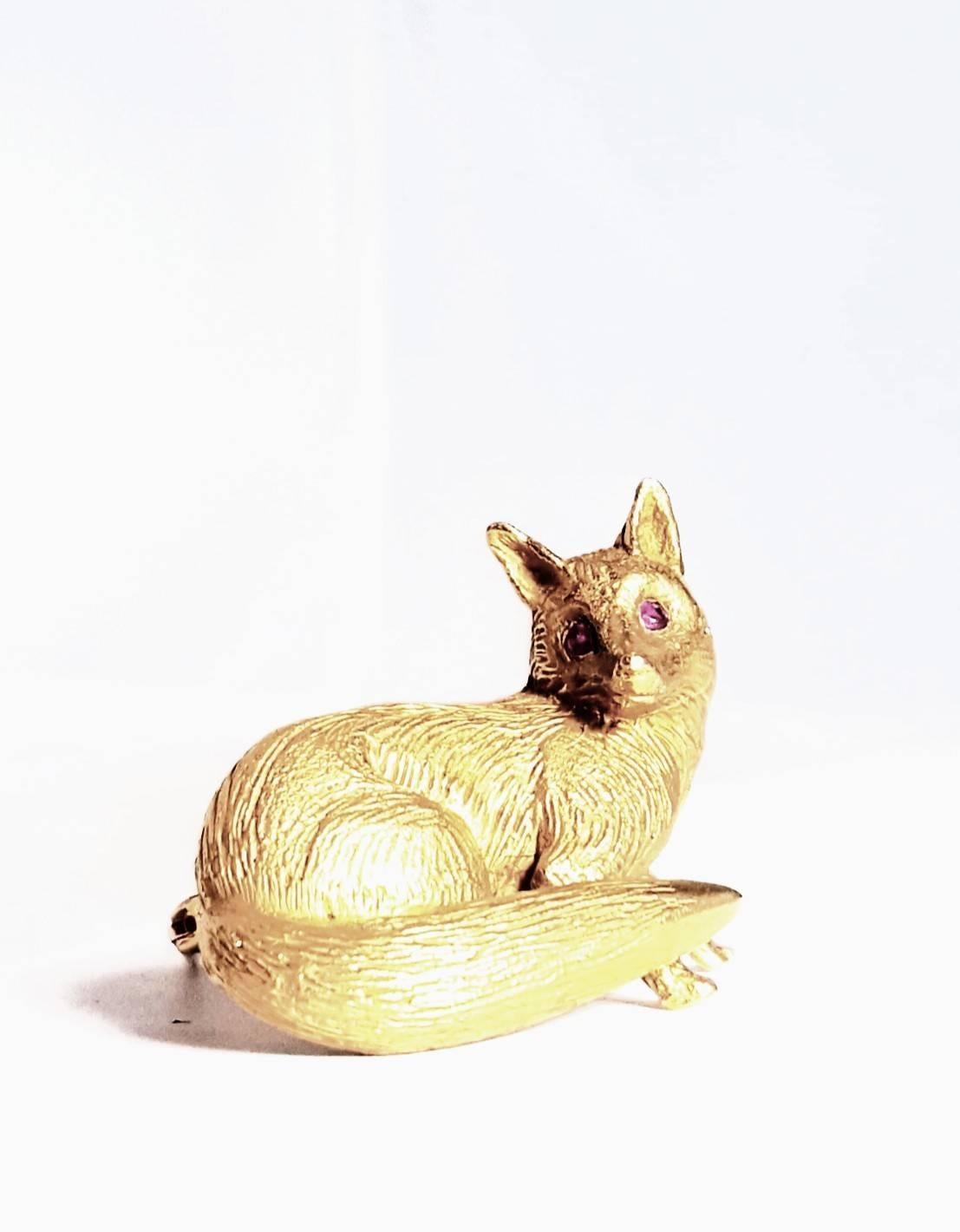 Meticulously crafted by Craig Drake, Philadelphia's jet setting, bon vivant jeweler to the elite!  This sly fox has incredible carved detail and inset matched faceted ruby eyes.  A standout worn as a brooch or allow him to sit up on a dresser or