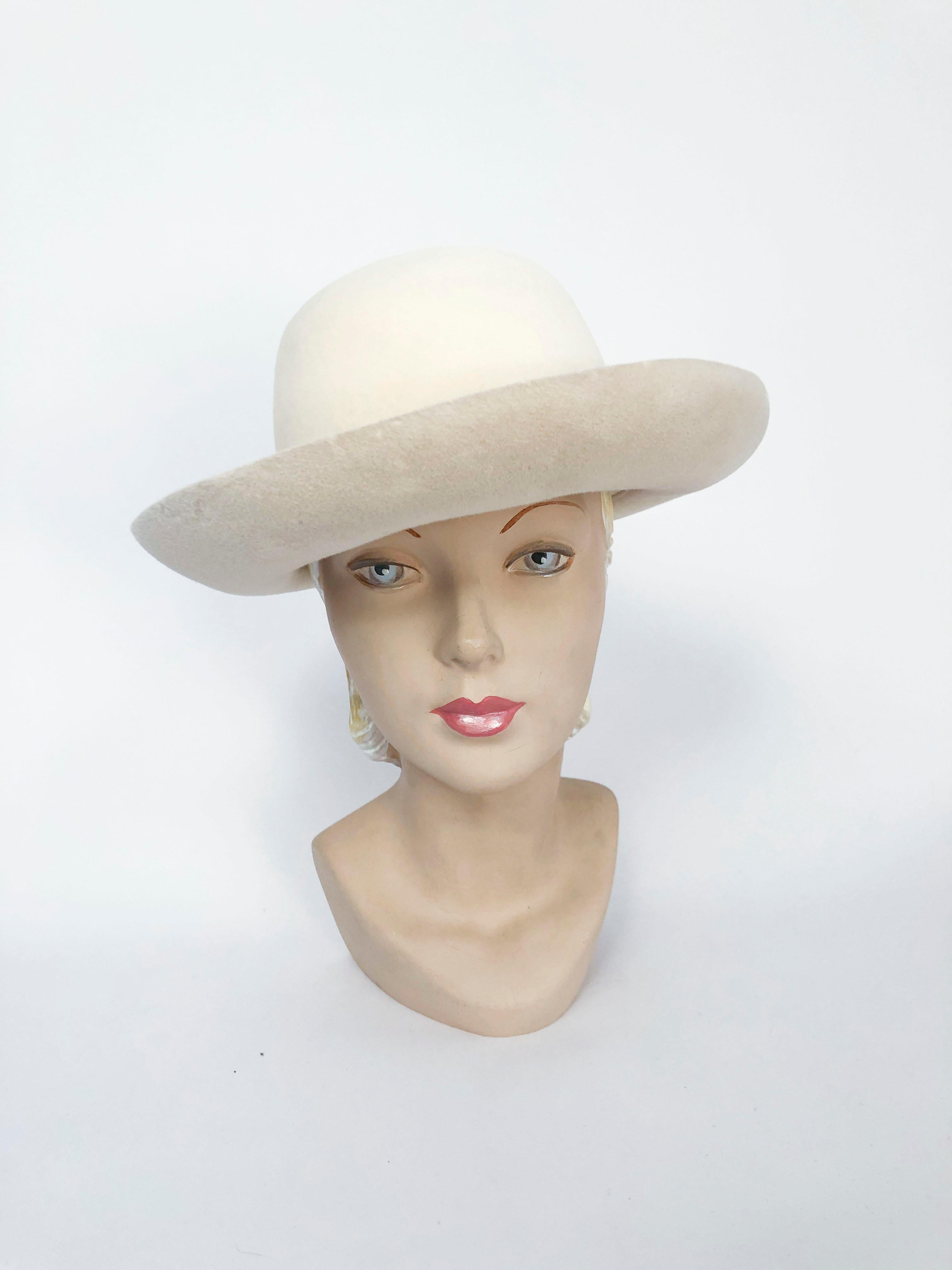 1970s Cream Borsalino Brimmed Hat with hand rolled  brim and bow. The hat is made of a beaver fur felt. Side hair clips attached to further secure the hat to the head