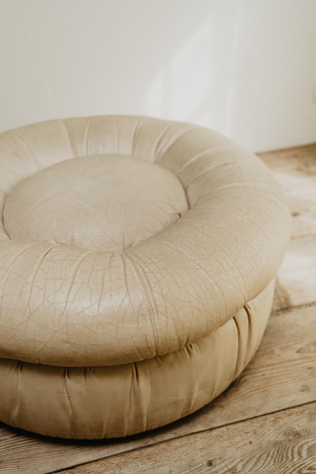 Lots of charm this leather pouf/ottoman from the 1970s.