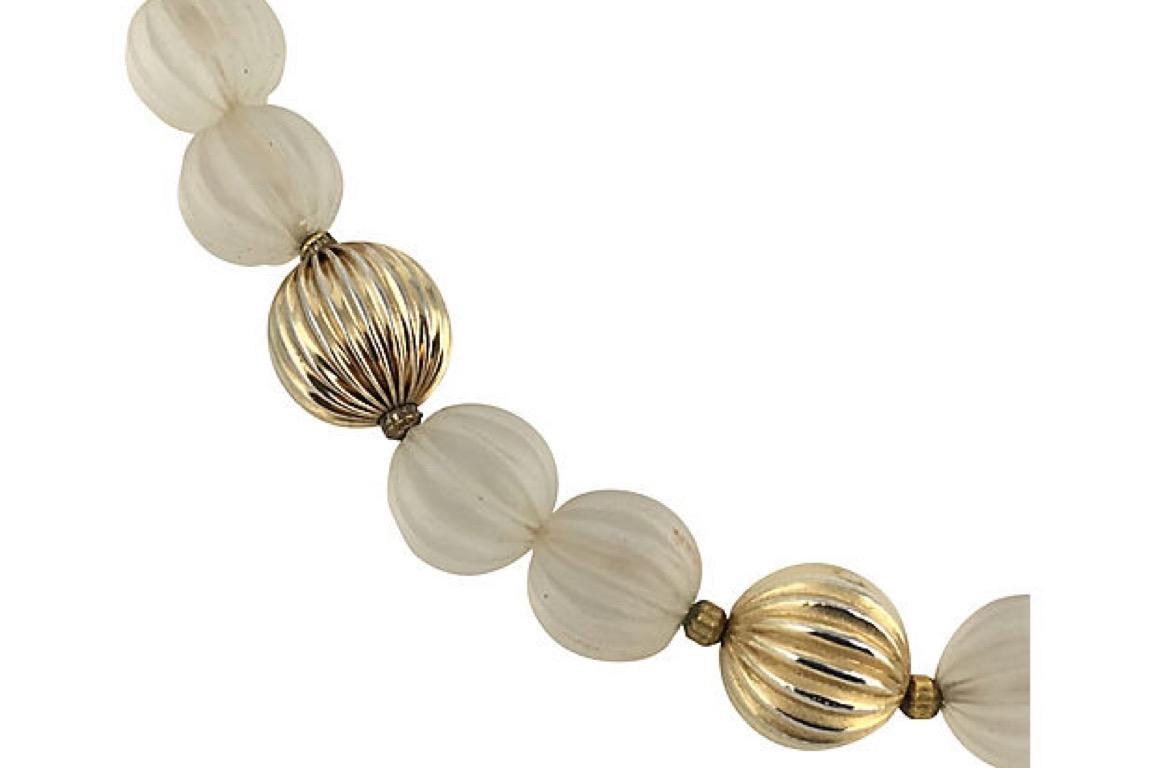 Ribbed crystal and goldtone beaded necklace with gold-plated clasp, circa 1970. Light scratches and tarnish.