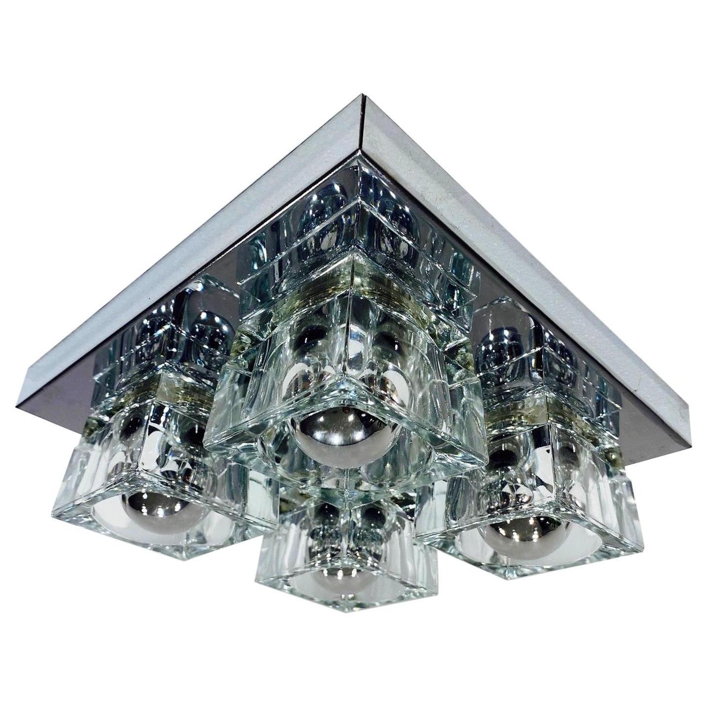 1970's vintage flush mount ceiling light with Cubist Design. The fixture has a square form comprised of a polished chrome frame fitted with four thick beveled glass block shades. Excellent scale for hallways, powder rooms or entryway. Can also be