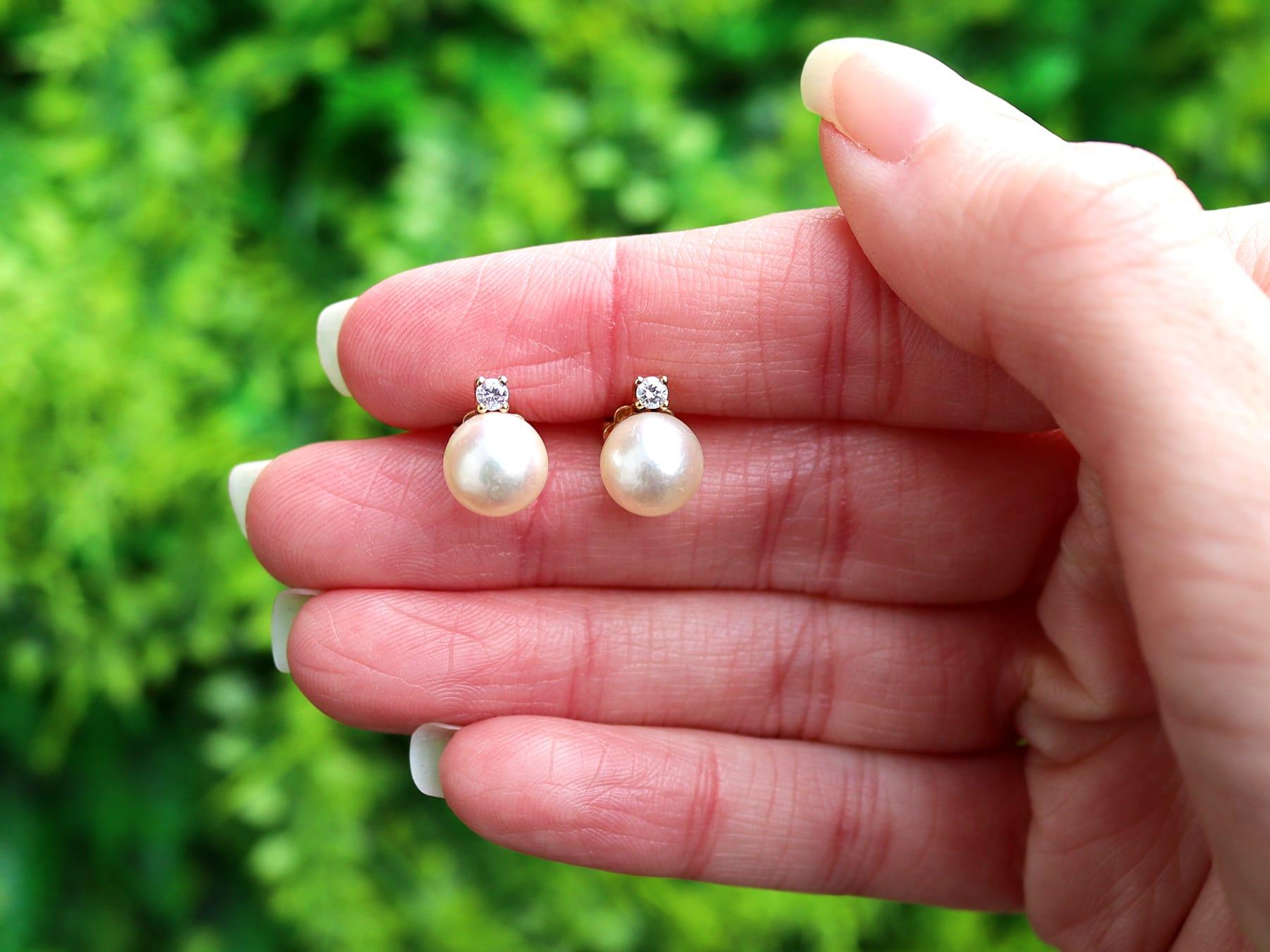 An impressive pair of vintage European cultured pearl and 0.06 carat diamond, 14 karat yellow gold stud earrings; part of our diverse pearl jewelry collections.

These fine and impressive vintage pearl stud earrings have been crafted in 14k yellow