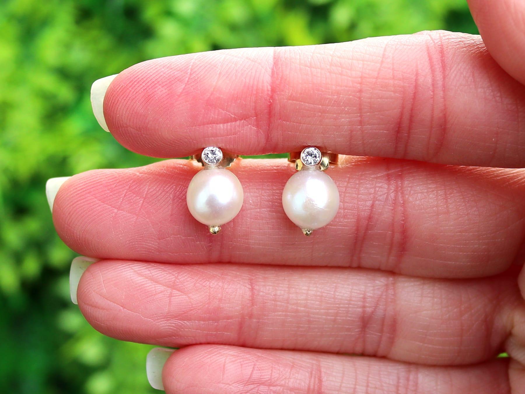 An impressive pair of vintage European cultured pearl and 0.06 carat diamond, 14k yellow gold stud earrings; part of our diverse pearl jewelry collection.

These fine and impressive vintage pearl studs have been crafted in 14k yellow gold.

Each