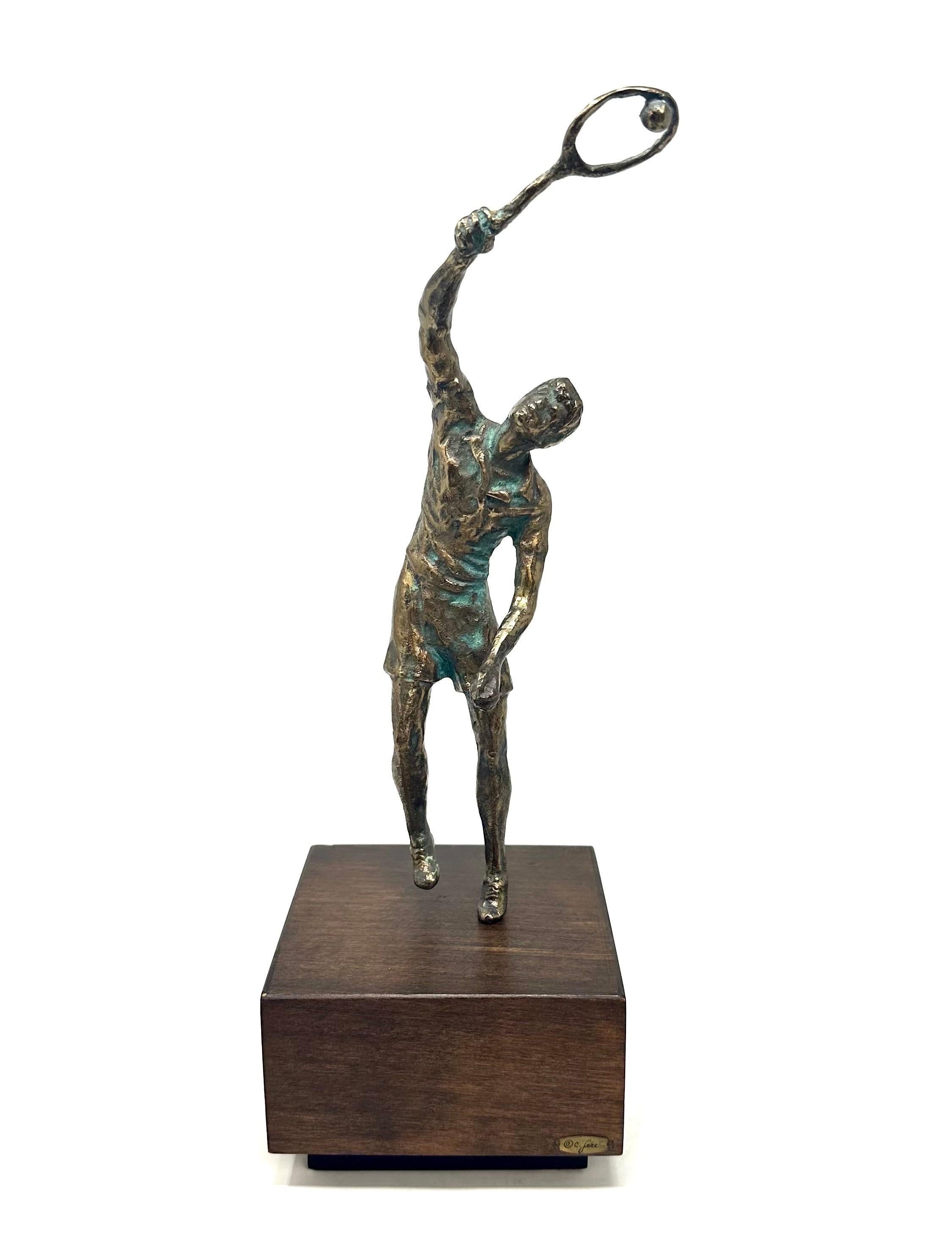 1970s bronze tennis player sculpture by Curtis Jere for Artisan House. The player stands on a wooden base, signed “C. Jere.” In excellent condition, with wear consistent with age and use.

Width 5.5 in / Depth: 5.5 in / Height: 15.75 in