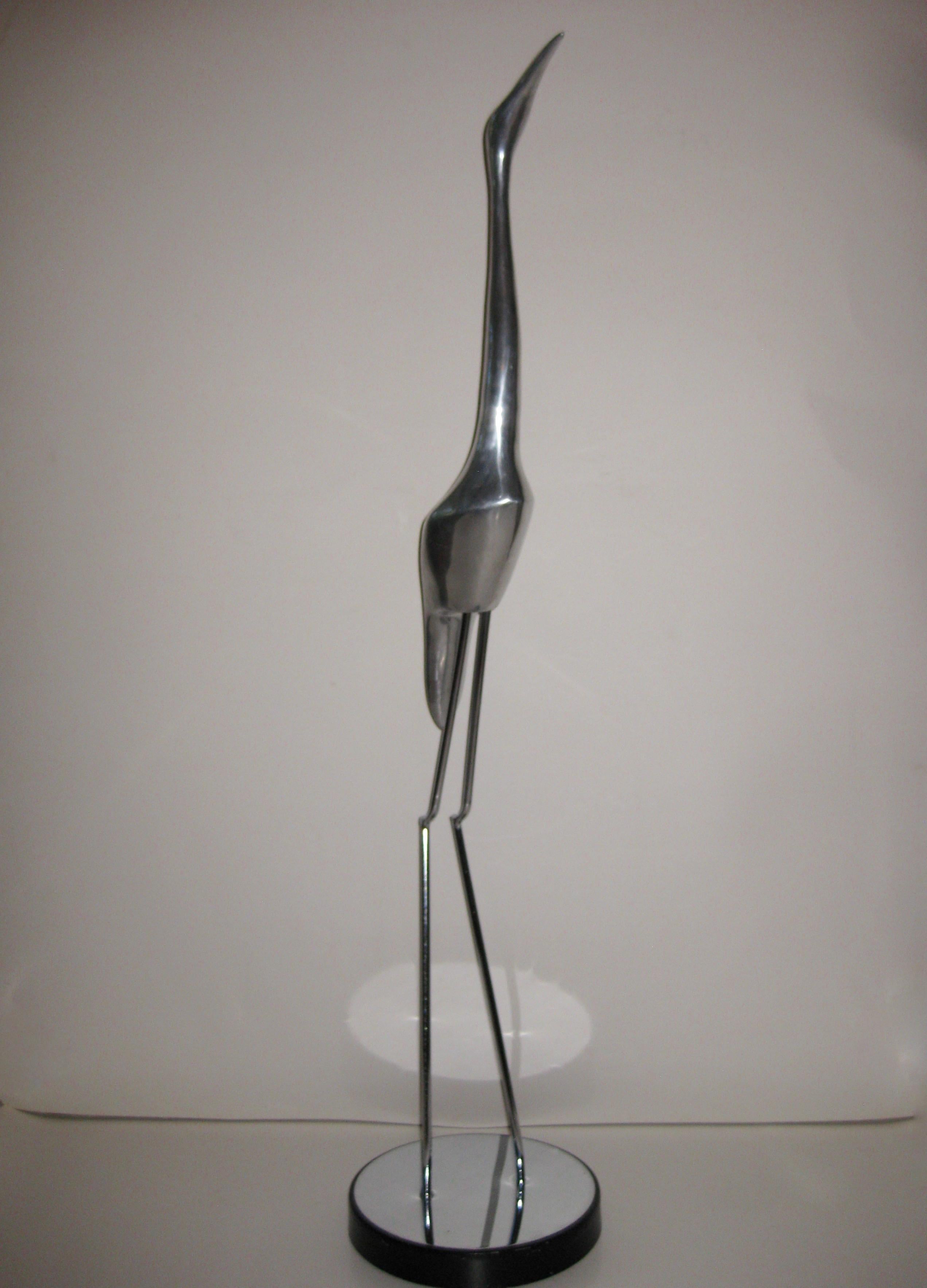 Created by Curtis Jere, this elegant, tall, 1970s floor sculpture is made of a polished, cast aluminium body with chromed metal legs and top plate on base. Base is made of black painted steel. Was signed “C. Jere” on base, but has been worn off.
   