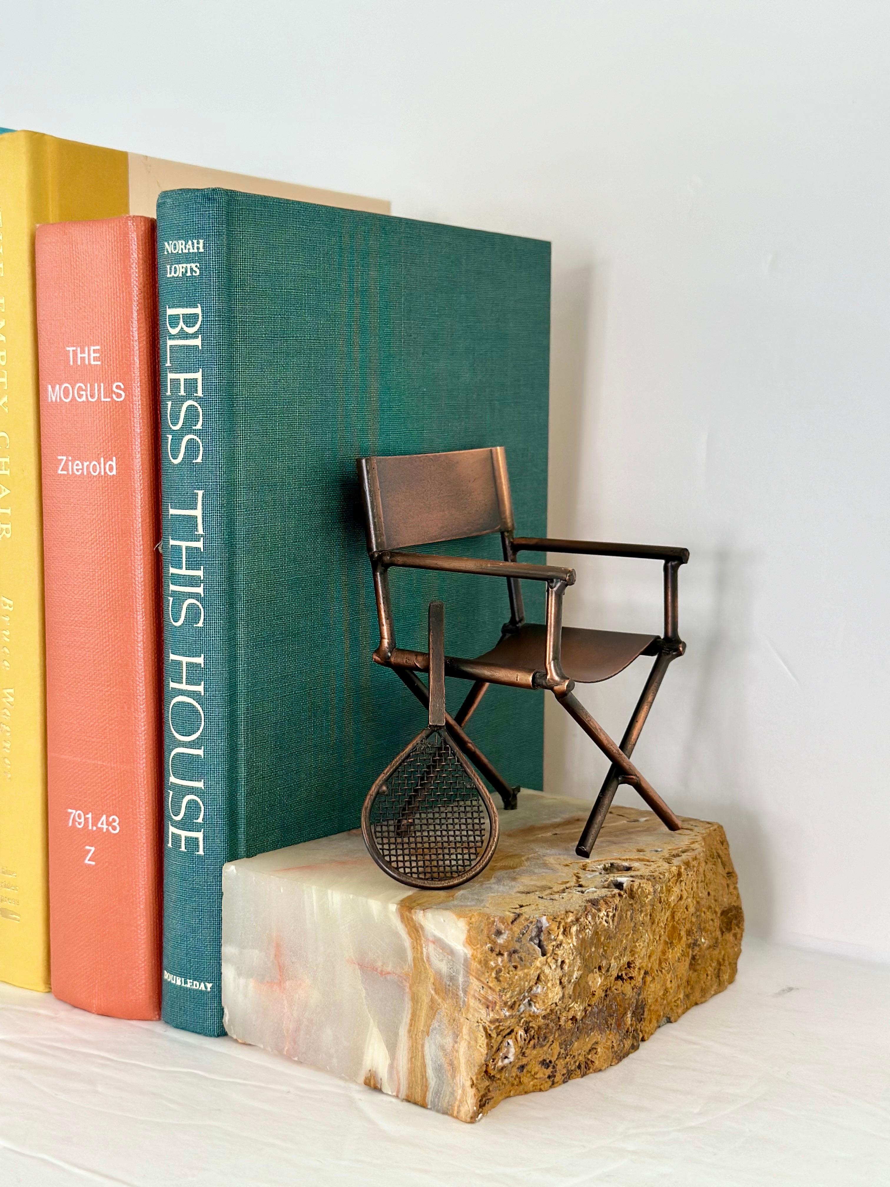 We are very pleased to offer a rare pair of bookends crafted by the renowned Mid-Century metal sculptor Curtis Jere, circa the 1960s.  Each bookend features a beautifully crafted copper figurine mounted on a rectangular onyx marble base.  The