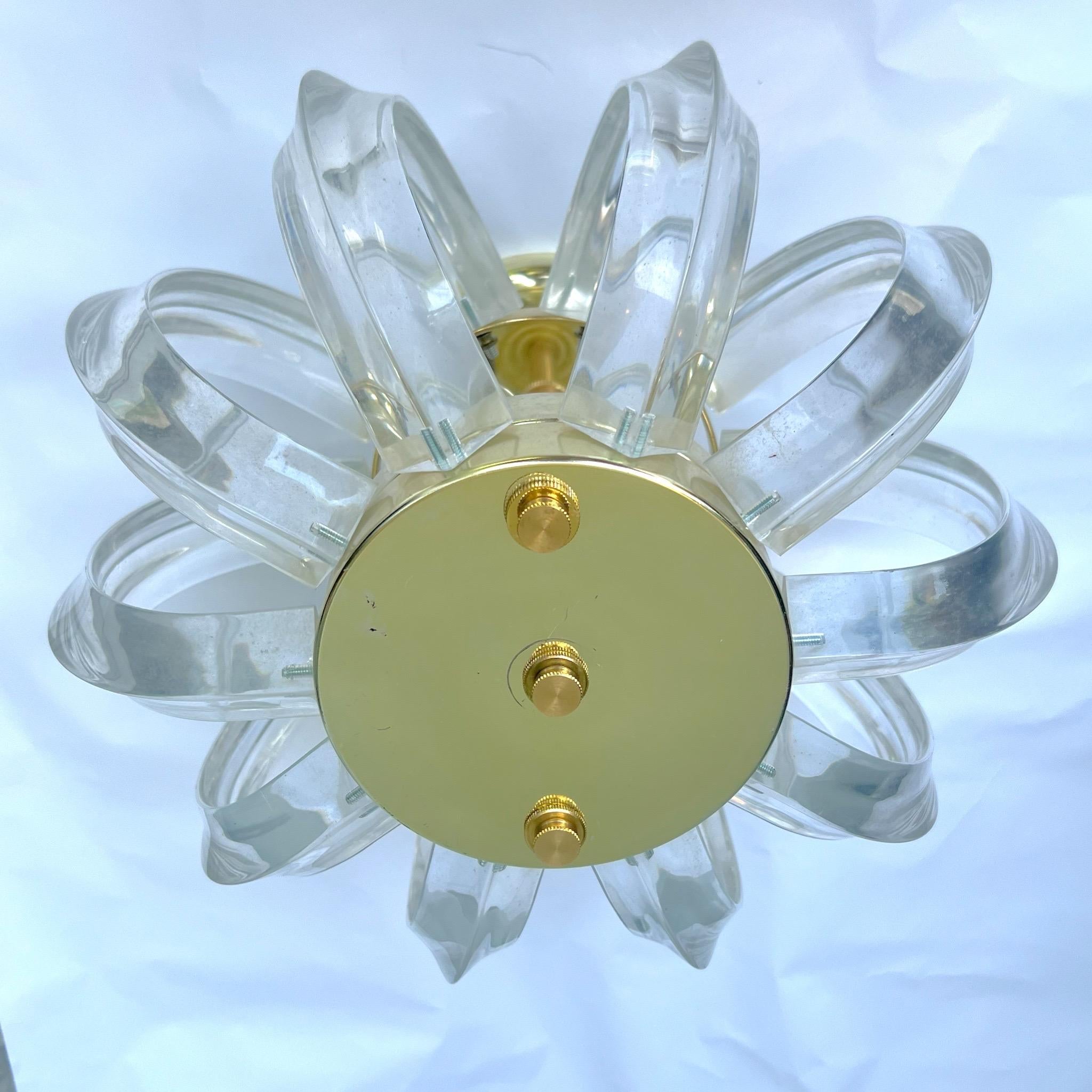 Vintage curved lucite and brass semi-flush chandelier.   Circa 1970’s. Takes 4 bulbs.  Professionally rewired. 