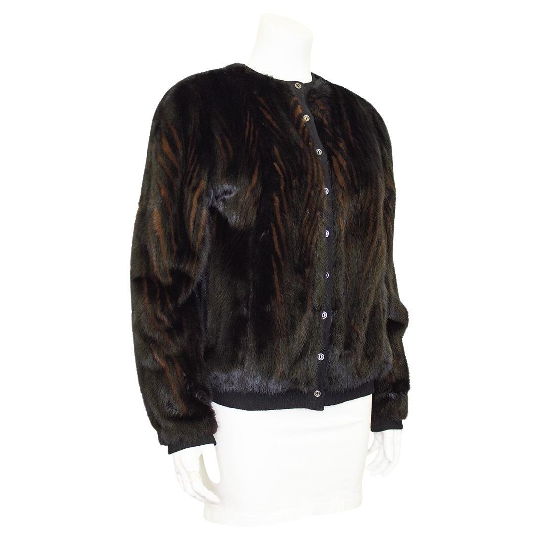 Cardigan/giacca bomber unisex in visone bicolore degli anni '70, realizzata su misura con una fodera in cashmere. Elegante e lussuosa rivisitazione del classico stile bomber con la morbidezza del visone a motivo chevron in rilievo nero e marrone