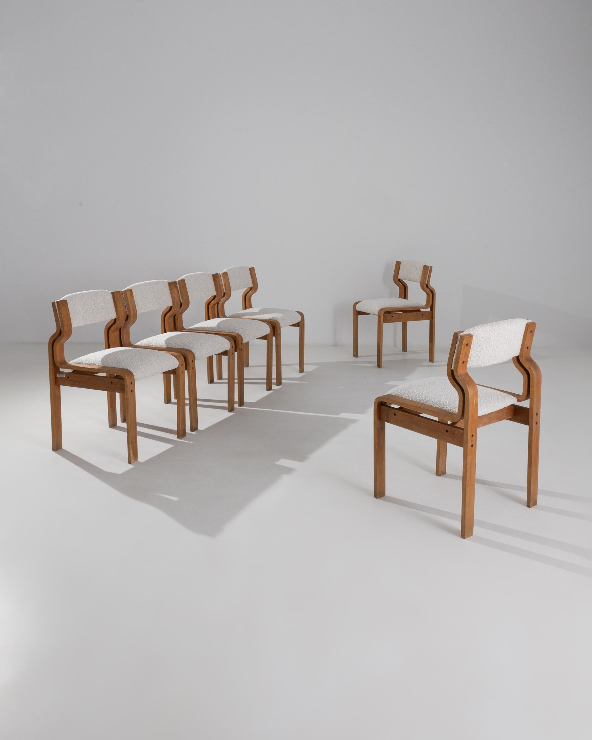 This set of six wooden dining chairs was made in the 1970s by renowned Czech Mid-Century Modern designer, Ludvik Volák. Many of his most acclaimed designs featured an innovative use of molded plywood which enabled him to create new and unusual