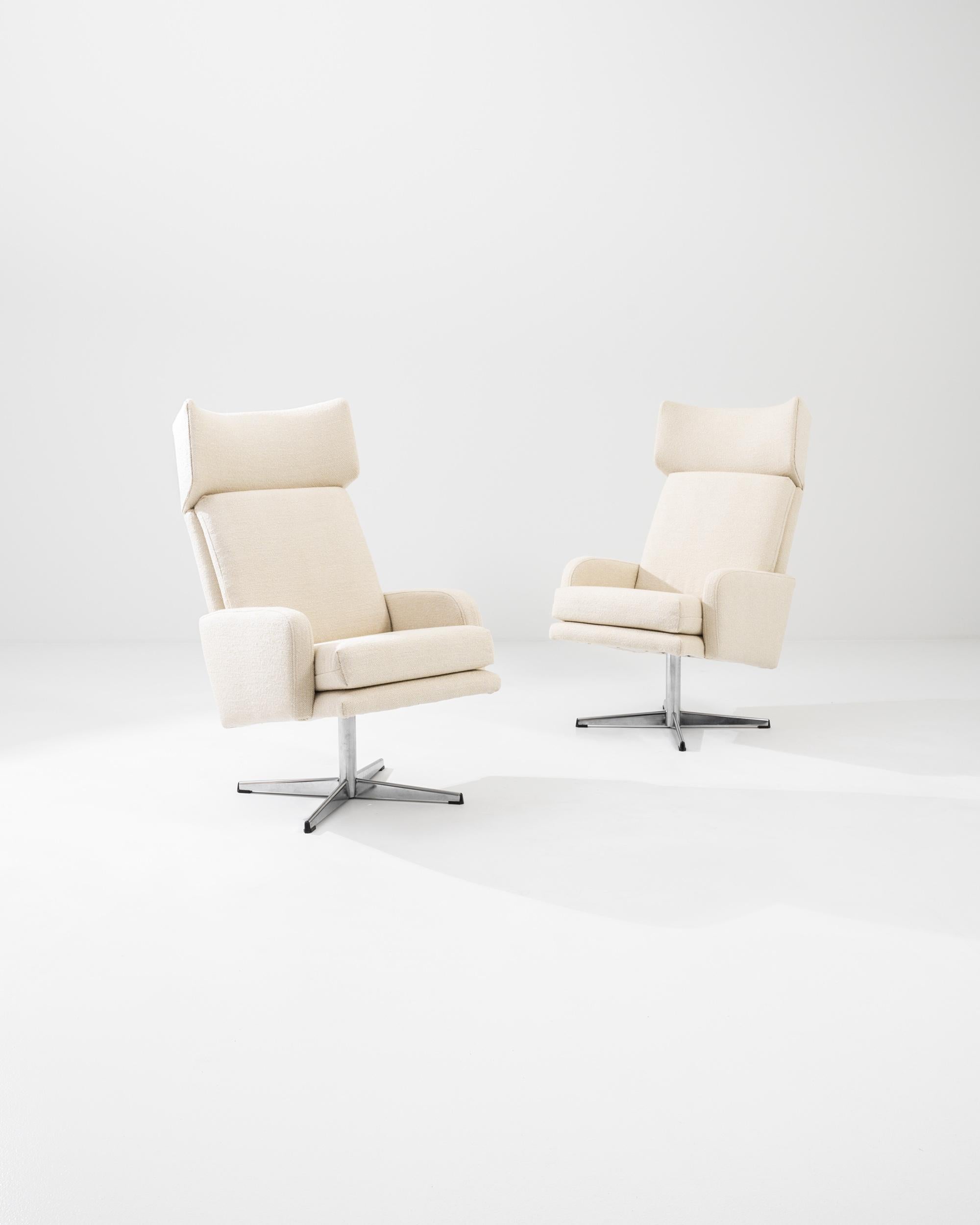 This vintage pair of rotary armchairs create an impression of luxury and productivity. The rotary chair was originally designed for industry, the swiveling movement allowed workers to reach things more easily at their desks, and this design from