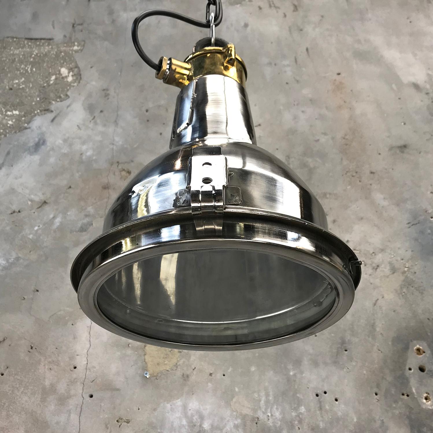 A retro industrial stainless steel and brass ceiling light. 

A great compact pendant ideal for hanging above snooker tables, kitchen islands, breakfast bars or dining tables.

Made by Daeyang, a manufacturer of industrial marine lights, this