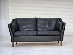 1970s, Danish 2-seater sofa, original black furniture leather, teak wood legs.
