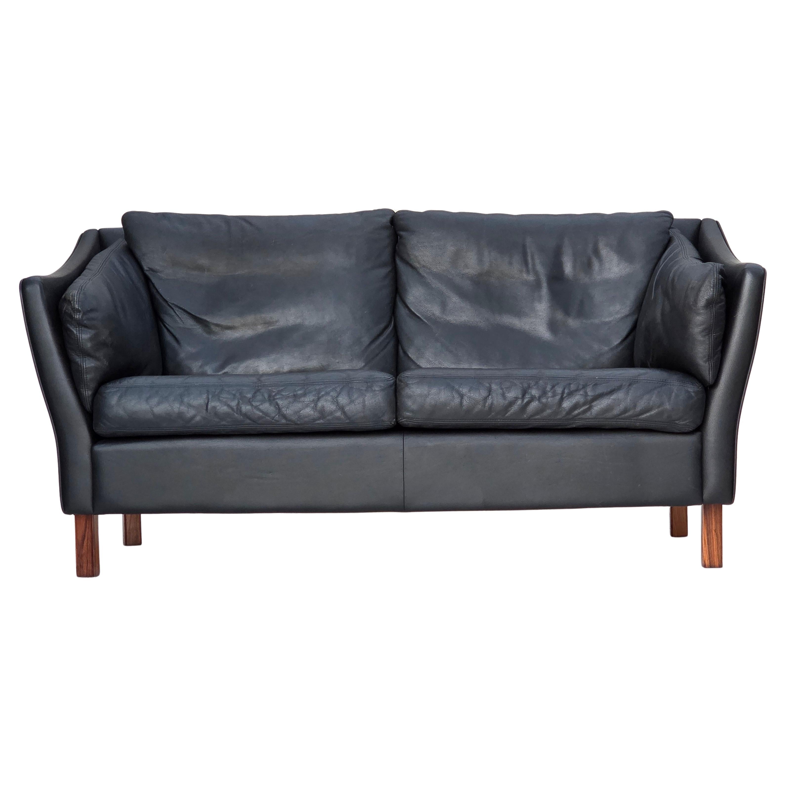 1970s, Danish 2-seater sofa, original black furniture leather, teak wood legs.