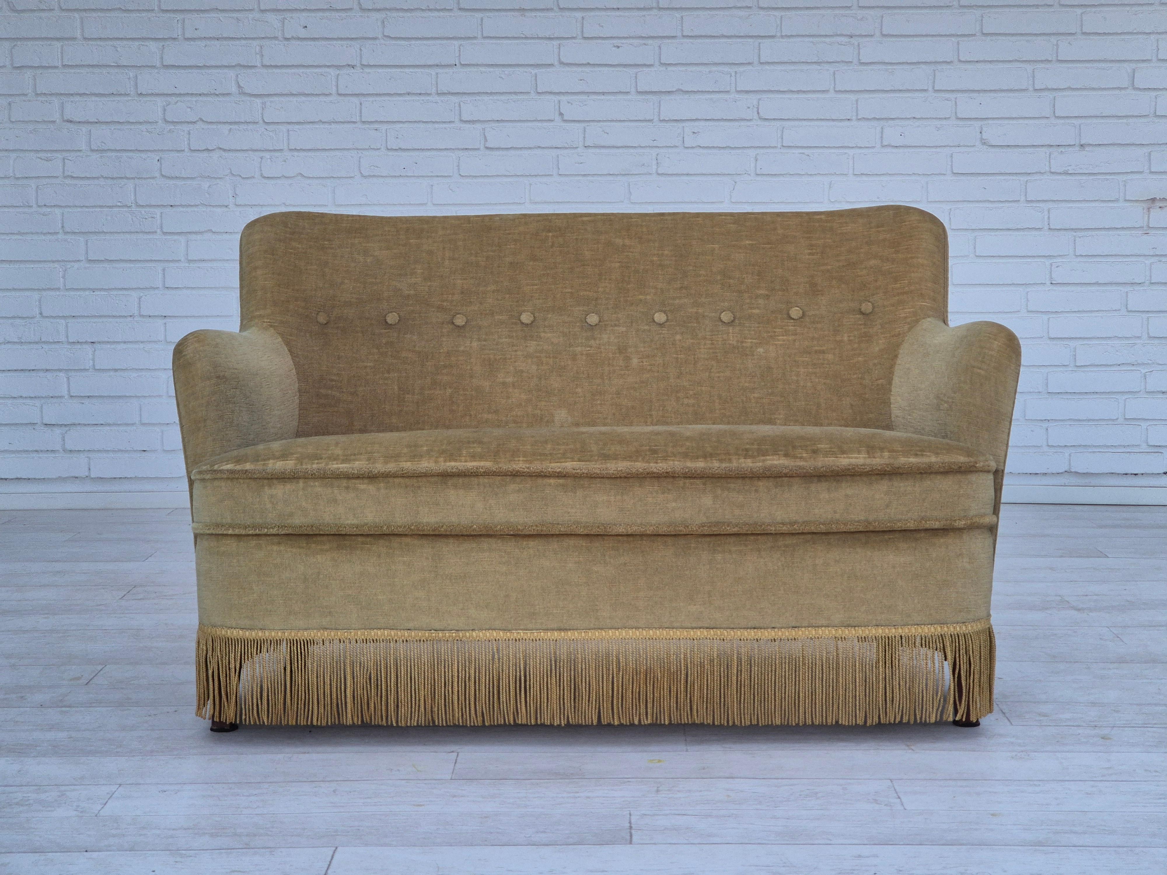 1970s, Danish little 2 seater sofa in original very good condition: no smells and no stains. Original light green furniture velour, beech wood legs. Springs in the seat. Manufactured by Danish furniture manufacturer in about 1970s.