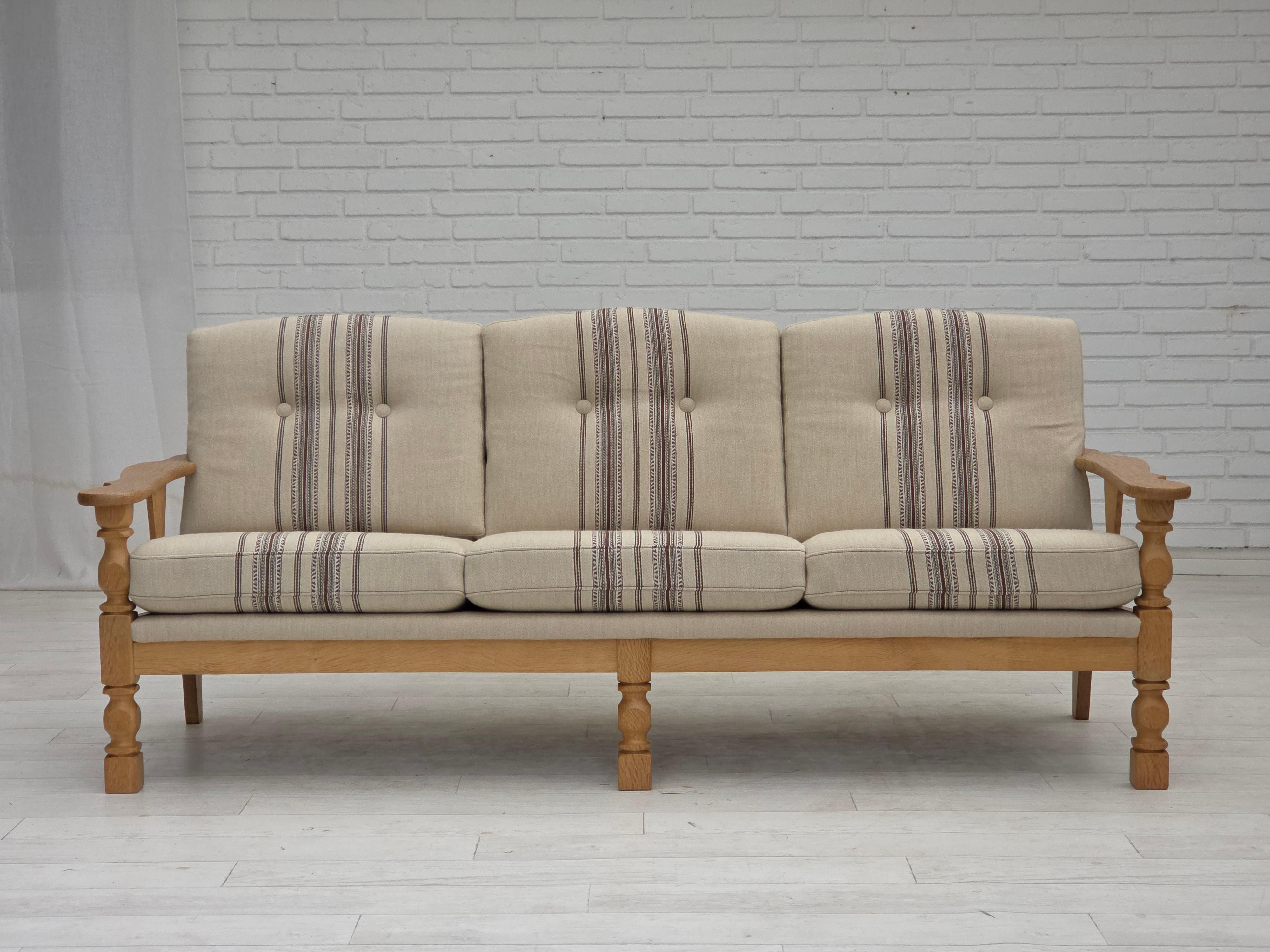 Divano danese a 3 posti degli anni '70. Mobili originali in lana beige, legno massiccio di Oak. Molle nei cuscini della seduta. Condizioni originali molto buone: nessun odore, nessuna macchia e struttura stabile. Prodotto da un produttore di mobili