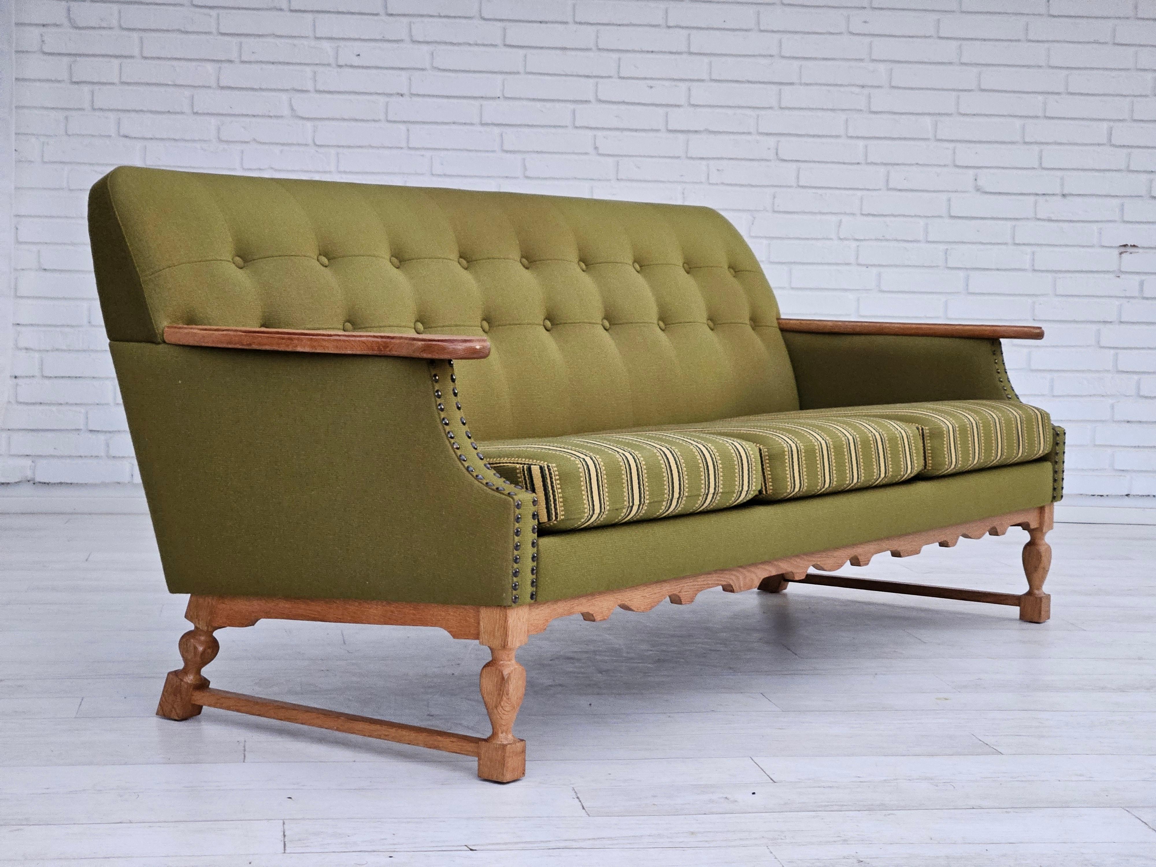 1970s, Danish 3 seater sofa. Original very good condition: no smells and no stains. Original olive green furniture wool fabric. Oak wood with springs inside. Manufactured by Danish furniture manufacturer in about 1970s.