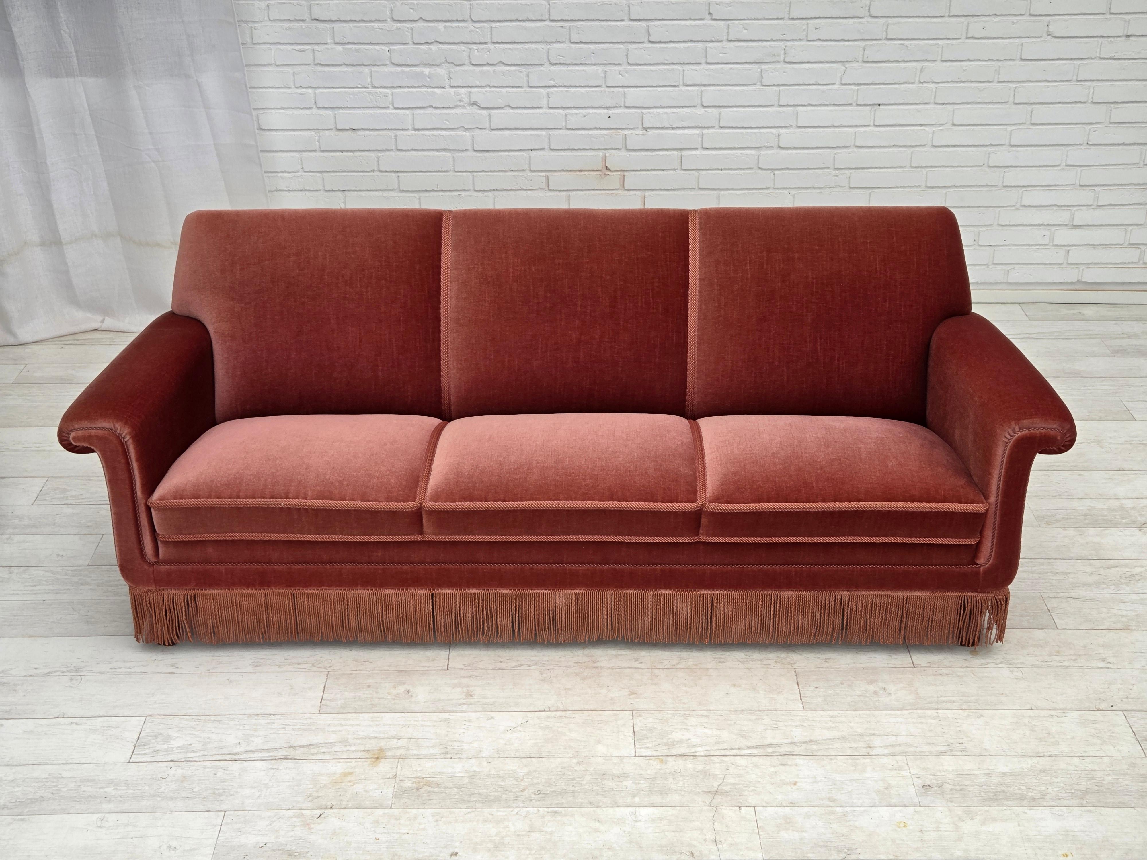 1970s, Danish 3-seater sofa. Salmon pink furniture velour, beech wood legs, springs in the seat. Original very good condition: no smells, no stains and stable construction. Manufactured by Danish furniture maker in about 1970-75s. Original