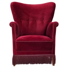Vintage 1970s, Danish armchair, cherry-red furniture velour, oak wood legs.
