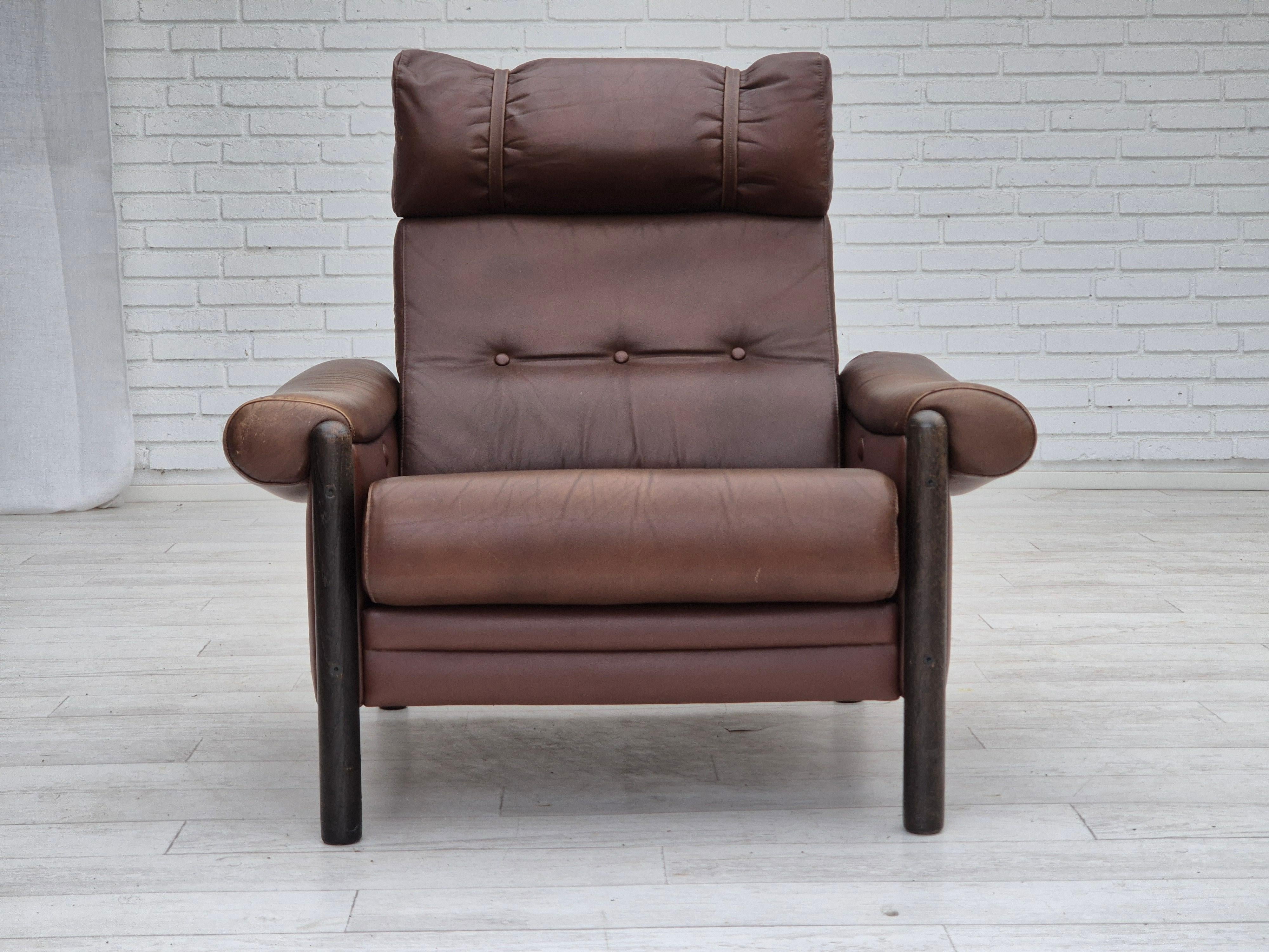 1970s, Danish armchair. Original good condition: no smells, no stains, and stable construction. Original brown furniture leather, dark oak wood. The chairs were bought by the previous owner in 1978s. Manufactured by Danish furniture maker in 1978s.