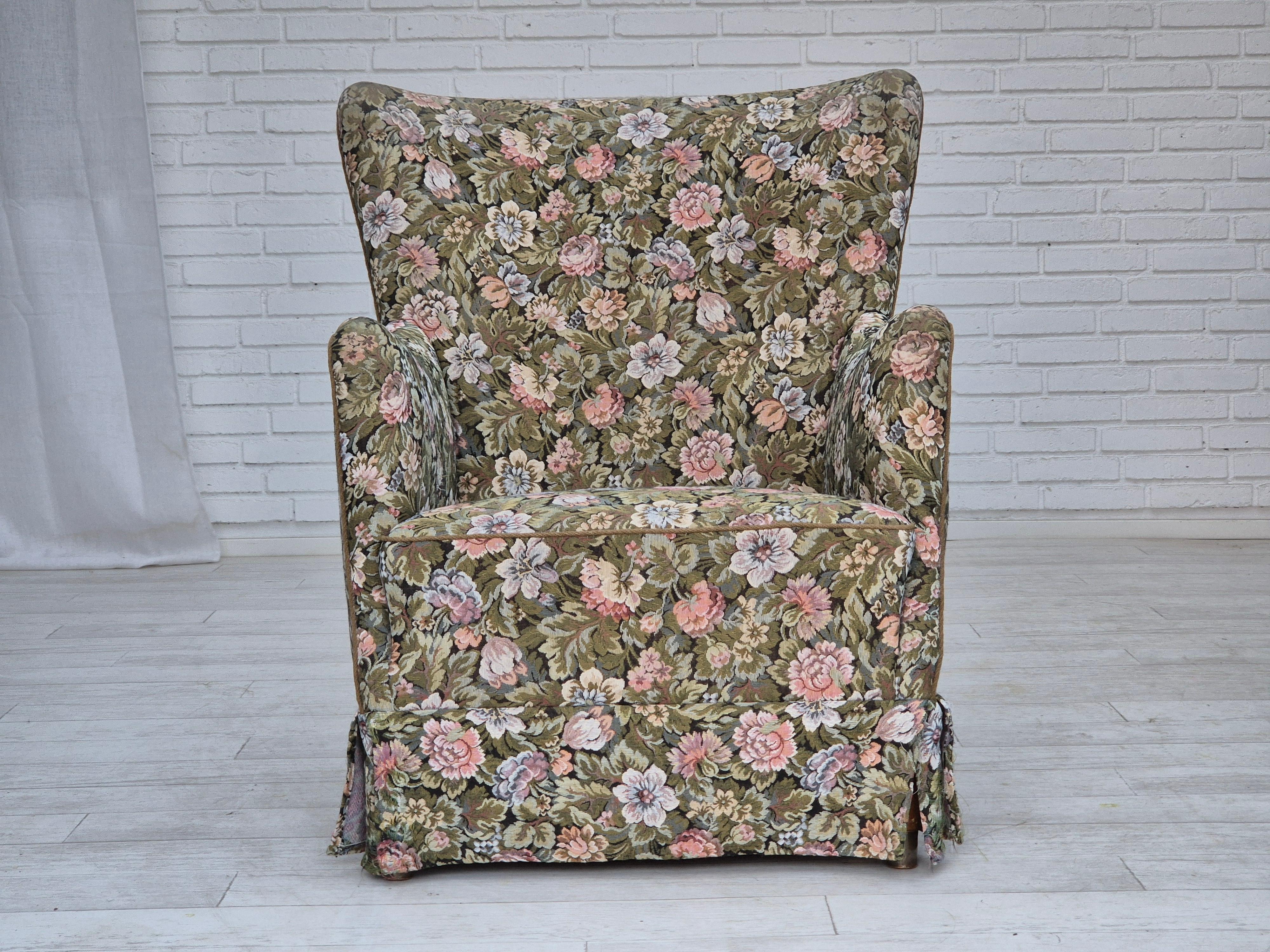 1970s, Danish armchair. Reupholstered about 15 years ago in flowers furniture fabric by craftsman. Good condition: no smells, no stains. Beech wood legs, front legs with brass covers. Brass springs in the seat. Manufactured by Danish furniture maker