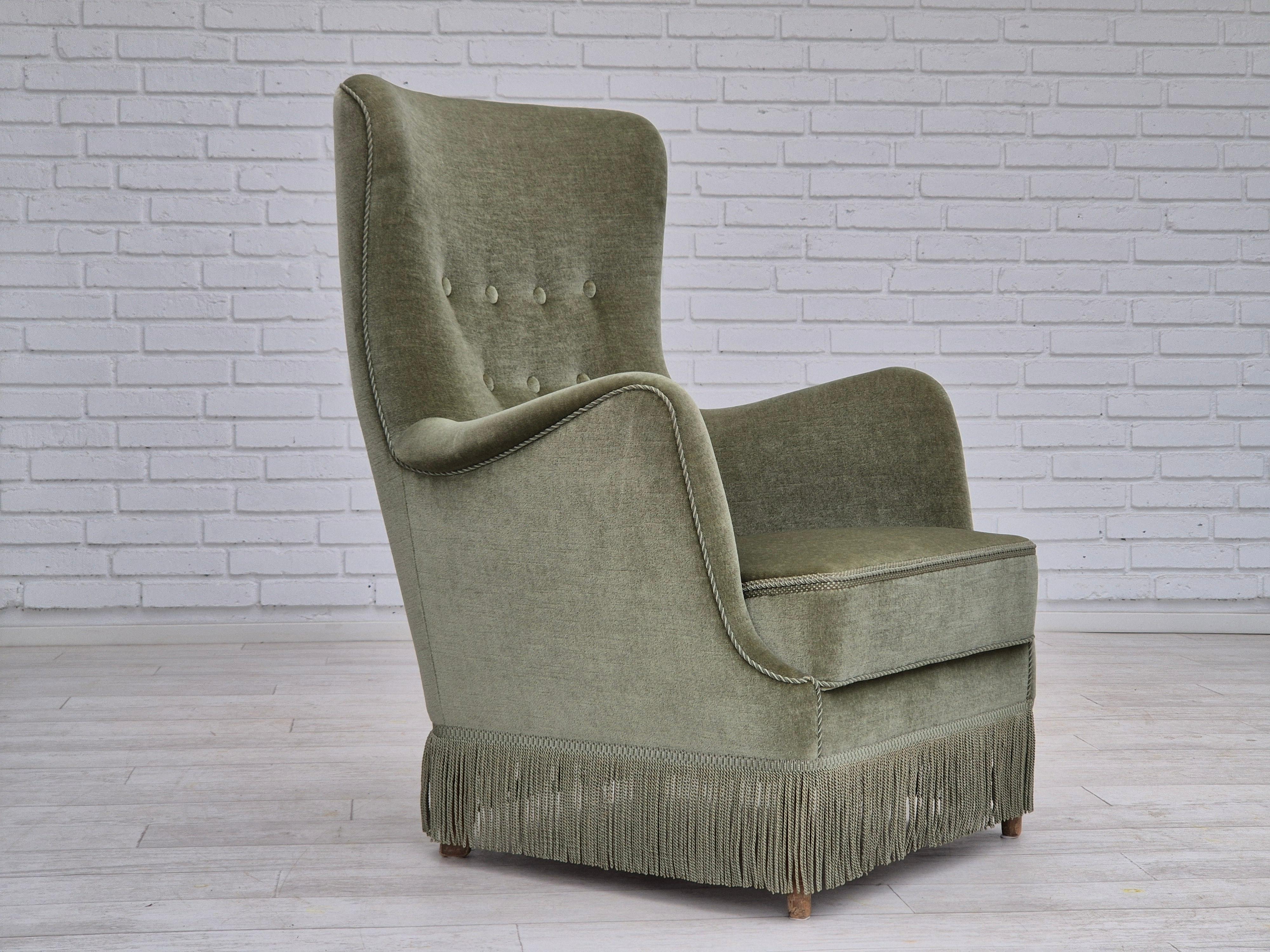 1970s, Danish armchair in original excellent condition. Used not too much from the 1970s. Light green furniture velour, beech wood legs. Springs in the seat. Manufactured by Danish furniture manufacturer in about 1970-75s. Chair comes directly from