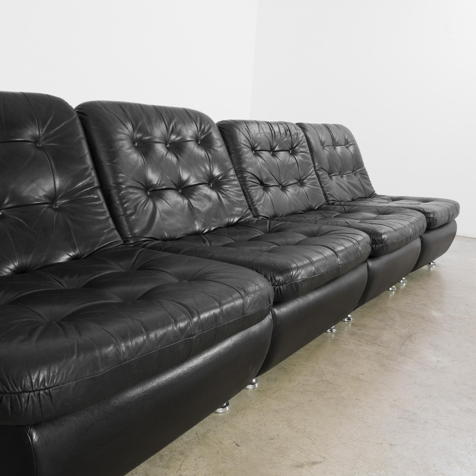 This four-piece black leather sofa was made in Denmark, circa 1970. Its versatility and use of top-quality leather make this an exemplar of Danish Modern design. The individual chairs can be arranged based on your desired configuration, and the
