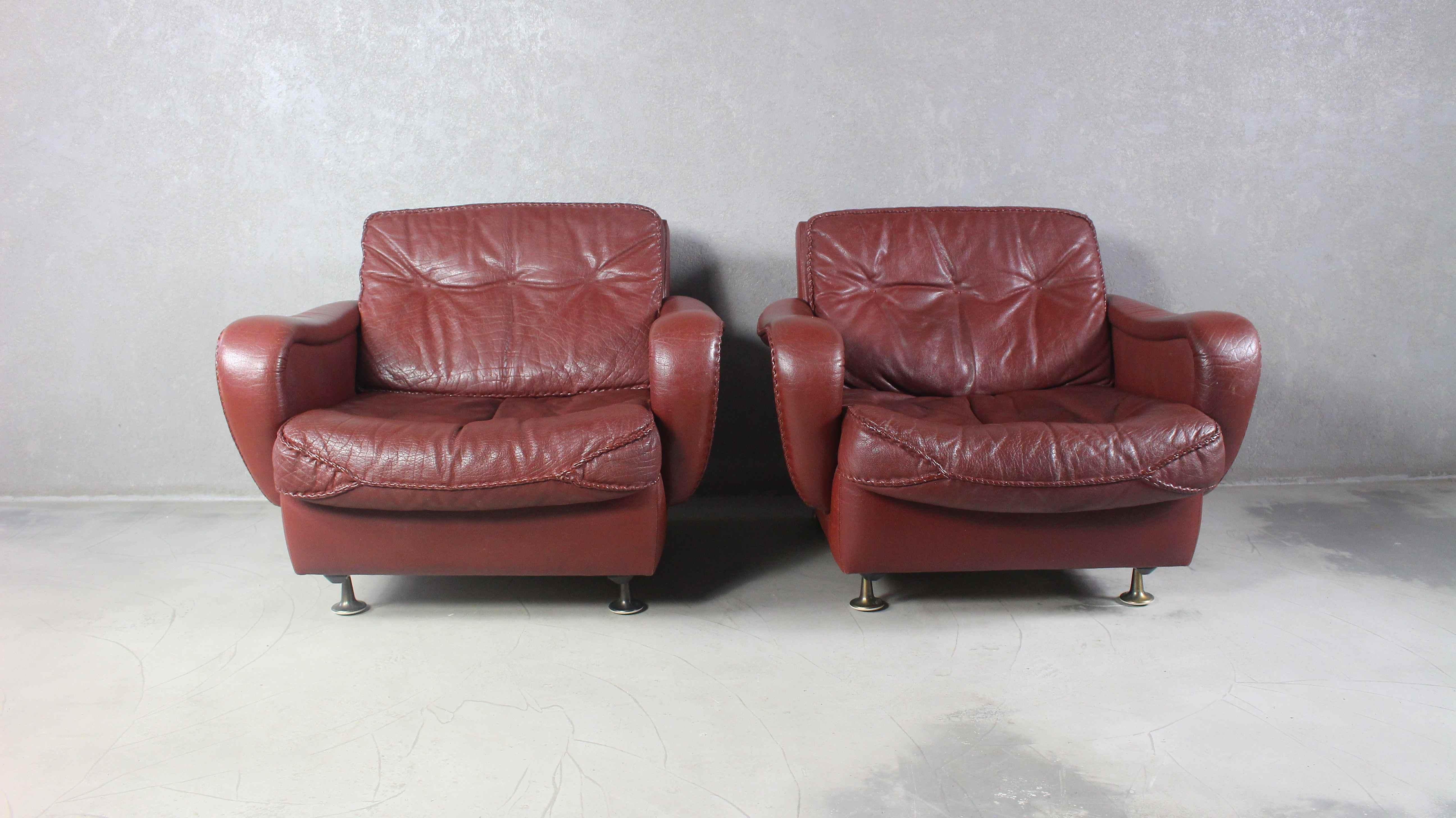 A very stylish Danish 1970s armchairs, designed by notable design duo Acton Schubell and IB Madsen.
The armchairs is upholstered throughout in genuine textured Buffalo leather, which is Brown in colour.
The backrest cushions feature light button