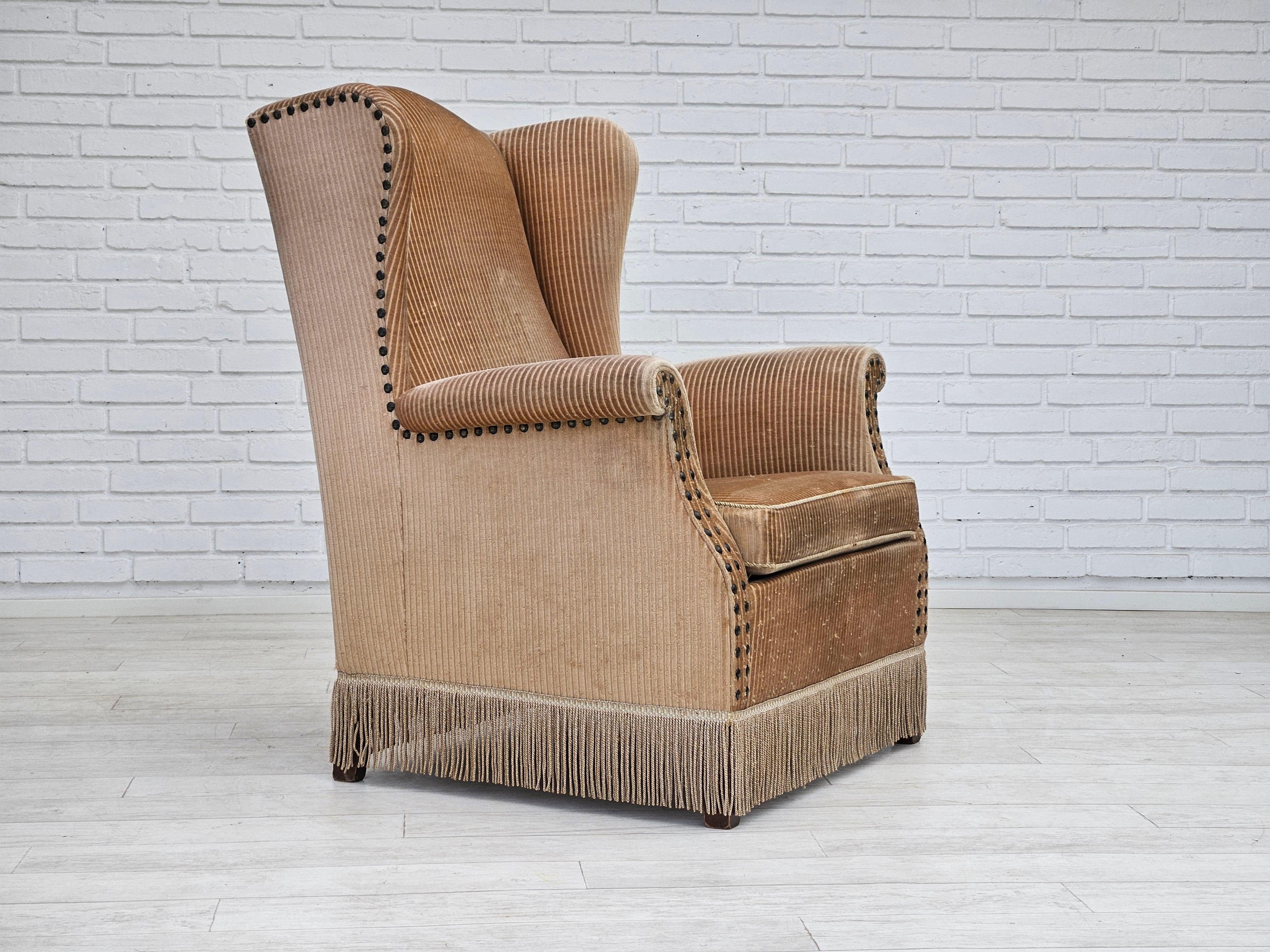 1970s, Danish design. High back armchair in beige corduroy. Original good condition: no smells and no stains. Ash wood legs, springs in seat cushion. Manufactured by a Danish furniture manufacturer in about 1970-75.